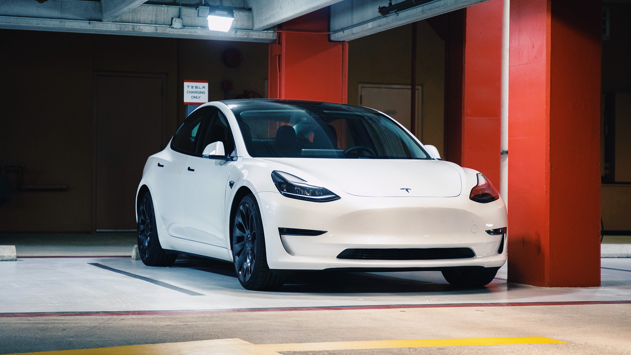 Photo of a Tesla car charging in a garage