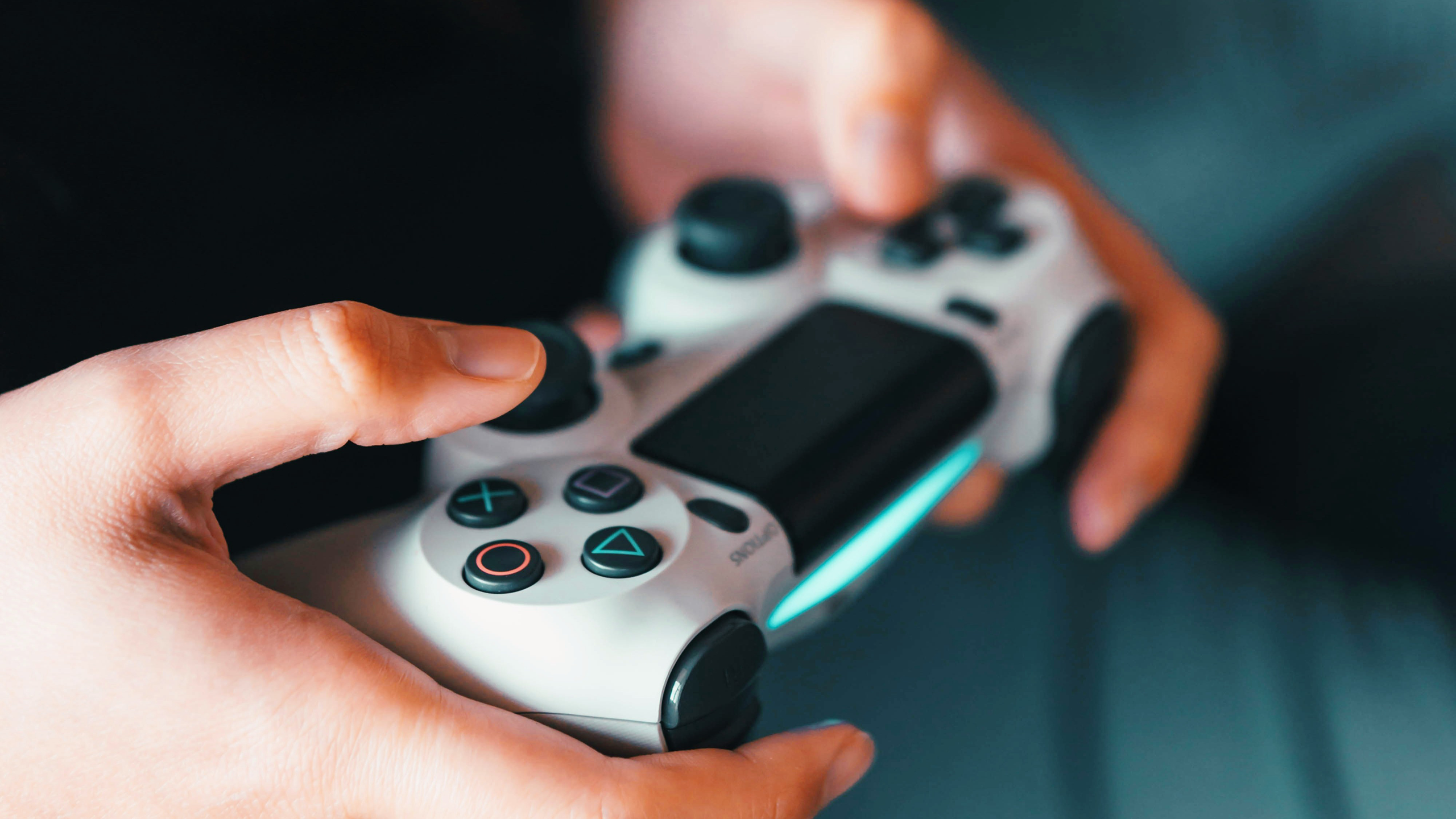 Photo of person holding a PlayStation controller