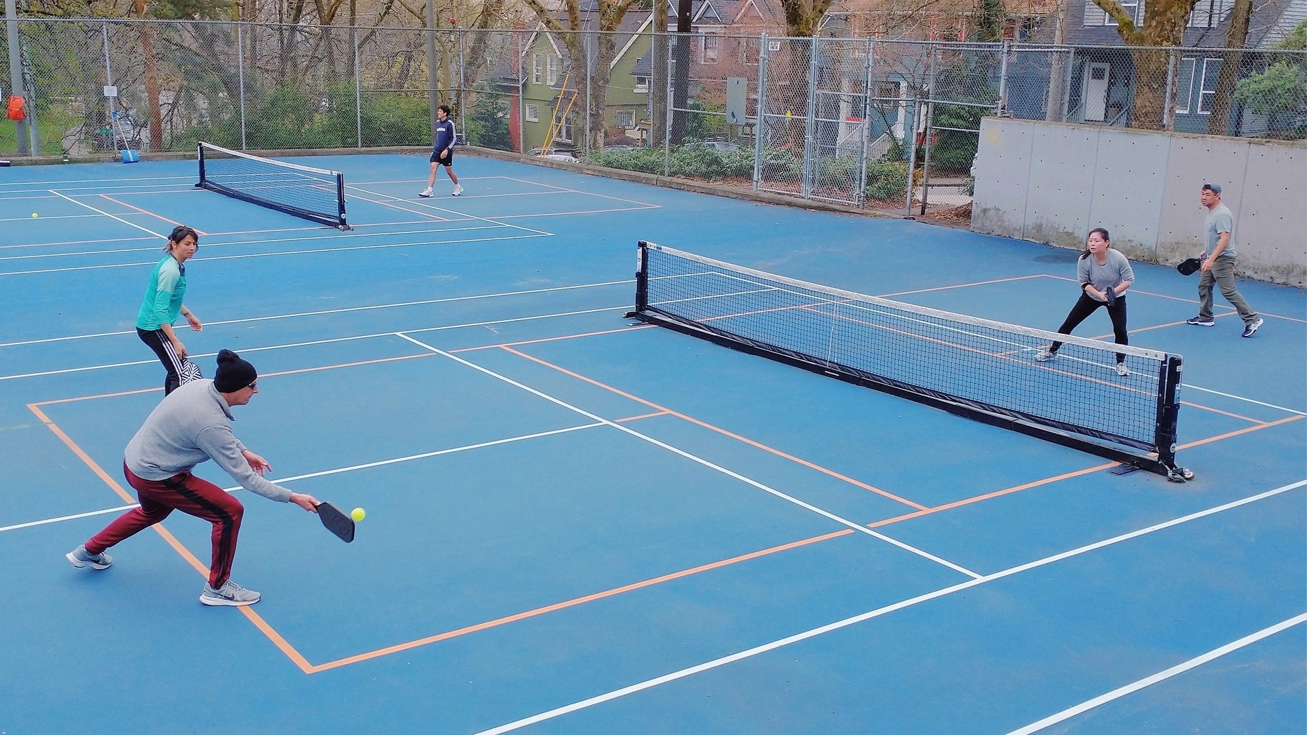 Photo of people playing pickle ball outside