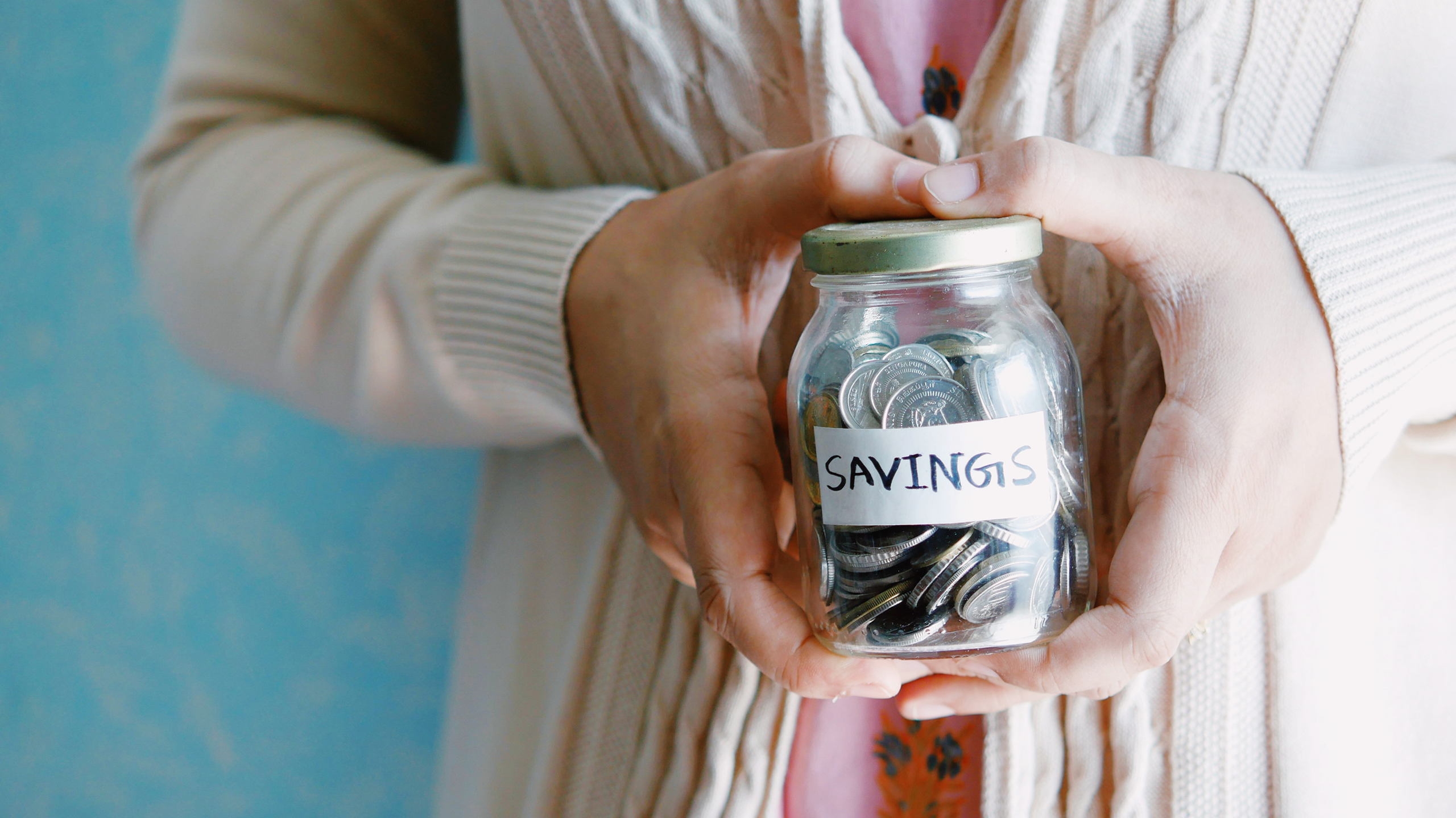 Photo of person holding a savings jar