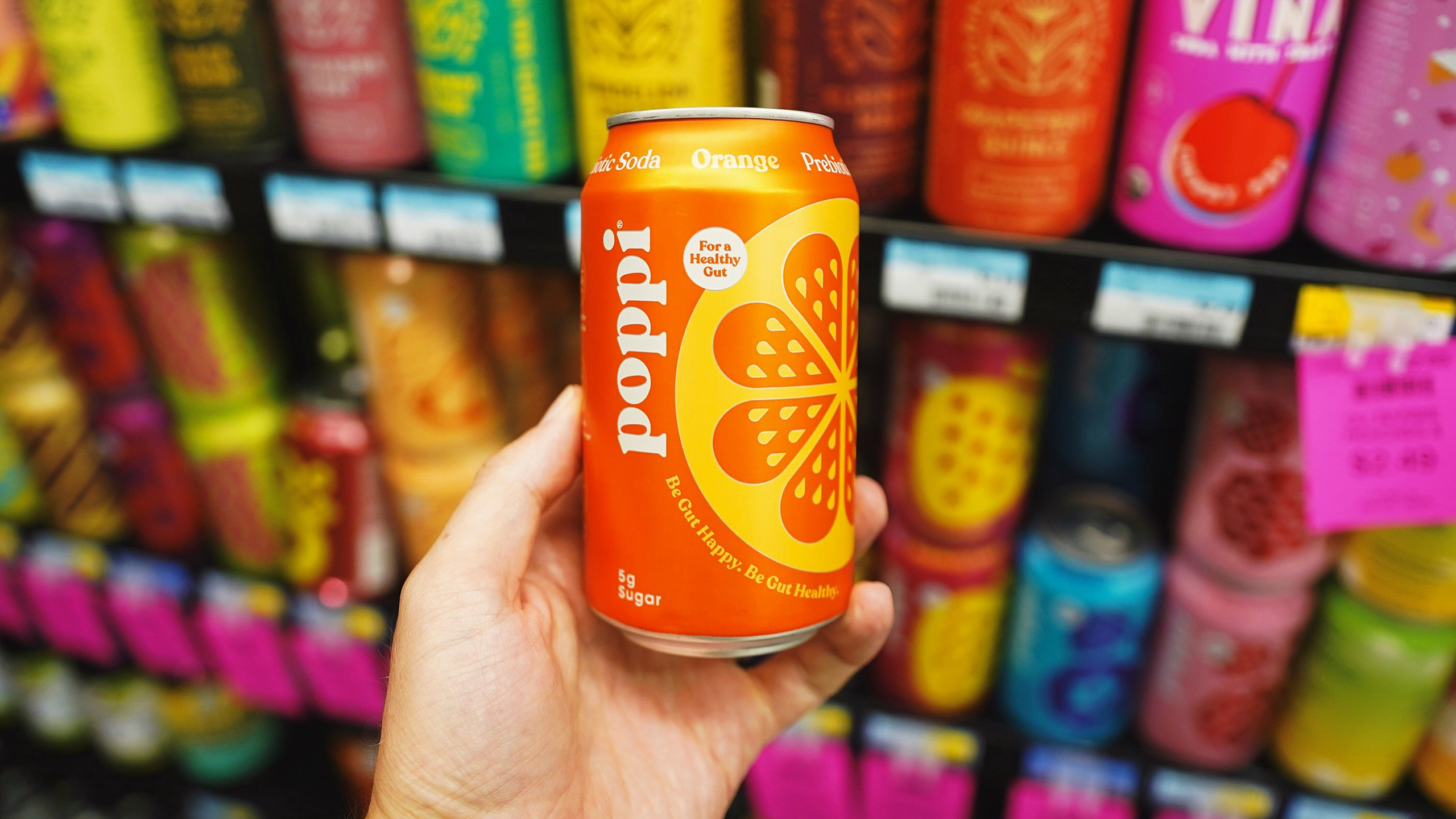 Photo of a person holding a can of Poppi
