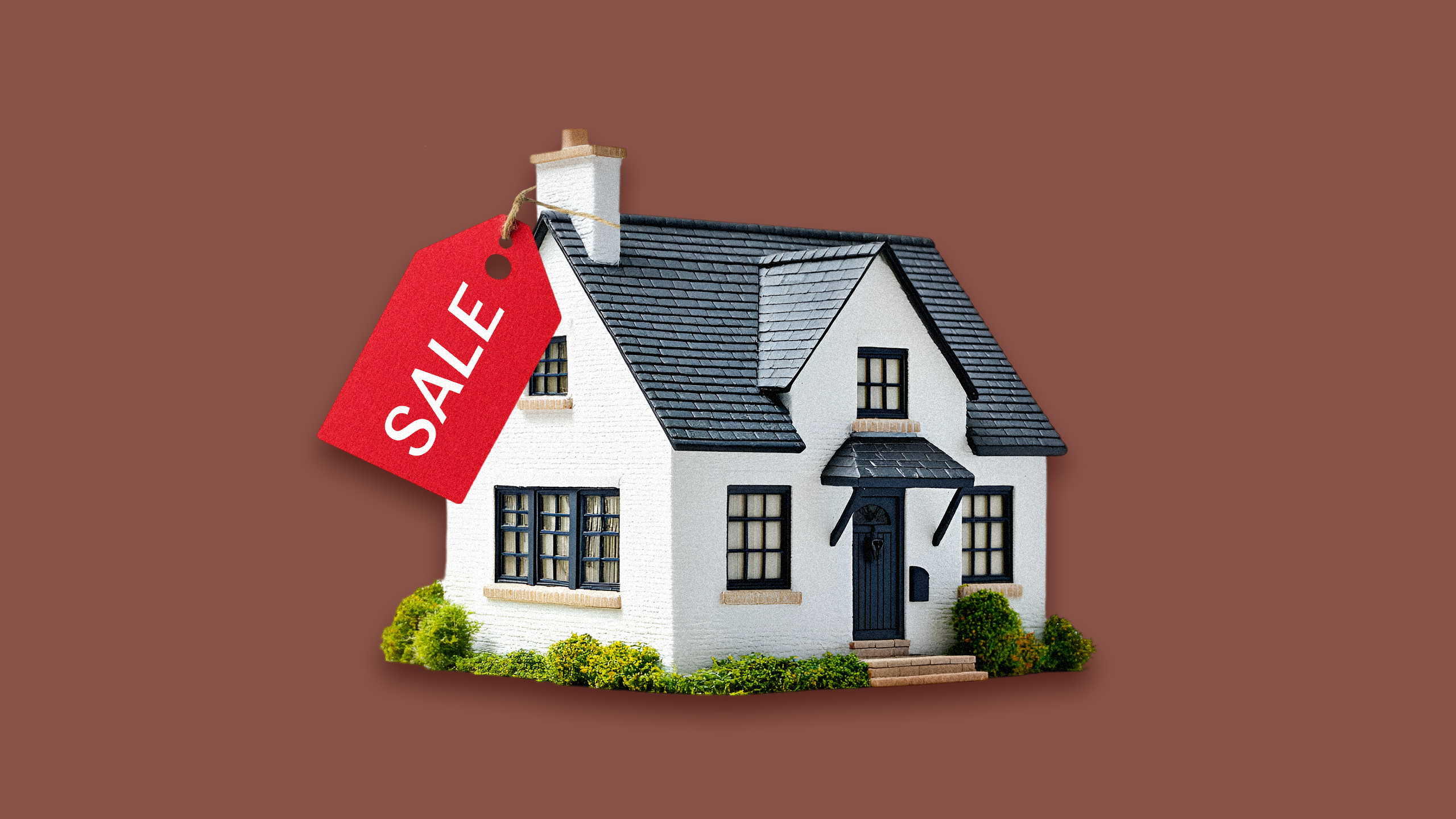 Photo of a house with a sale tag on it