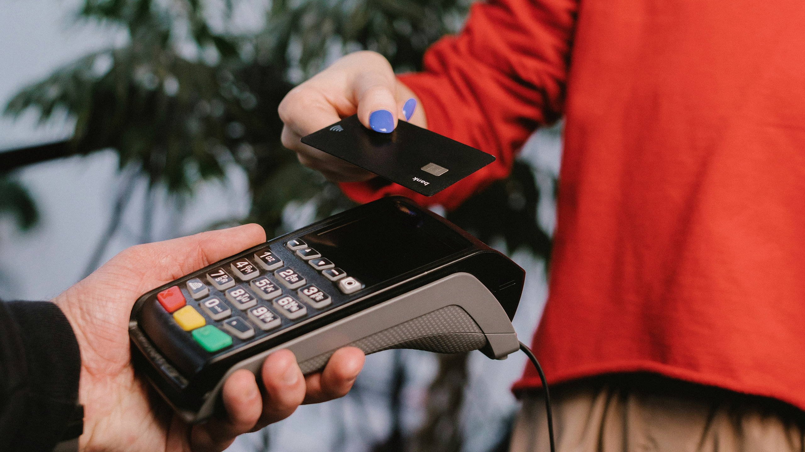 Photo of a person completing a credit card transaction