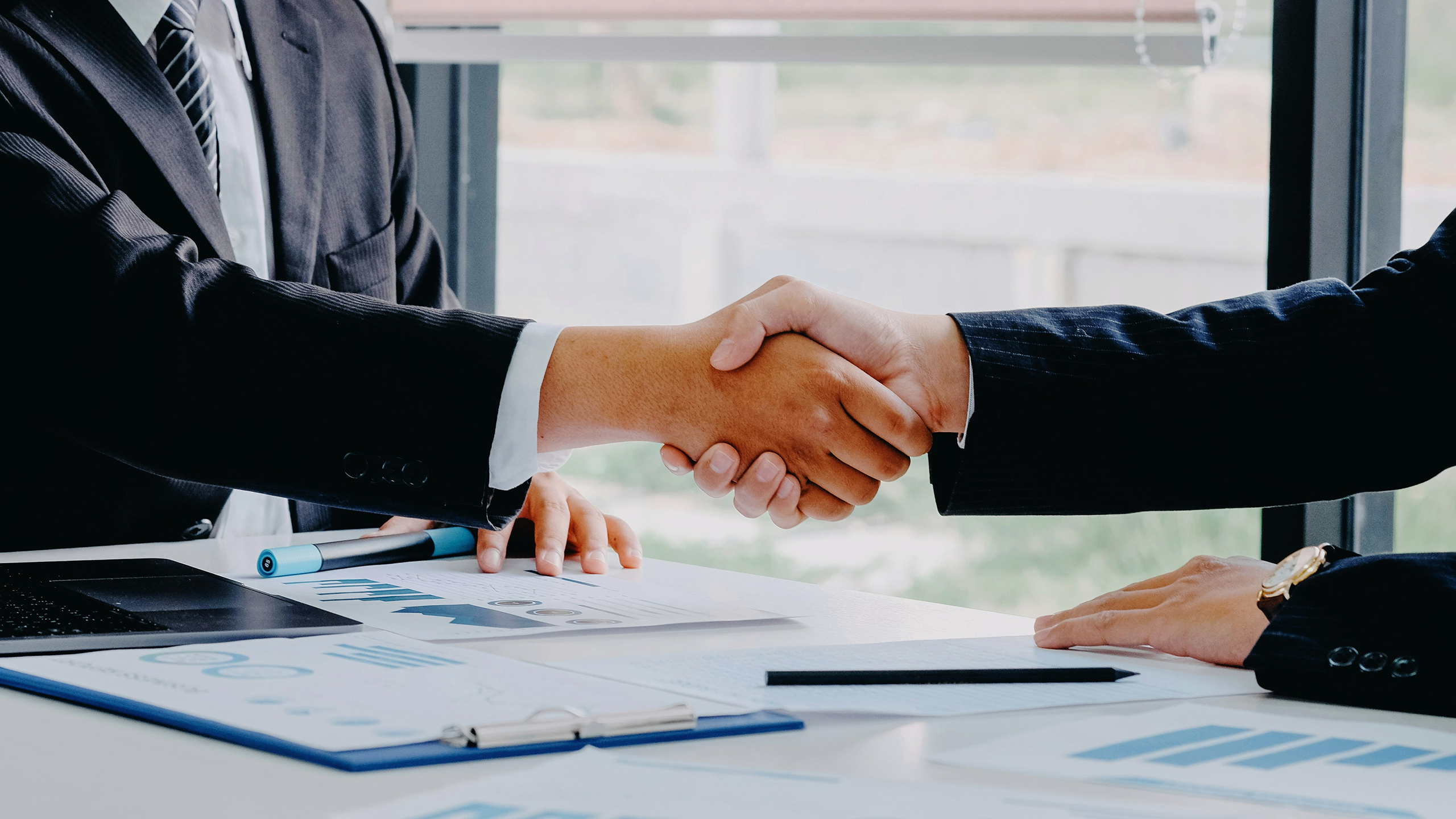 Photo of two business people shaking hands