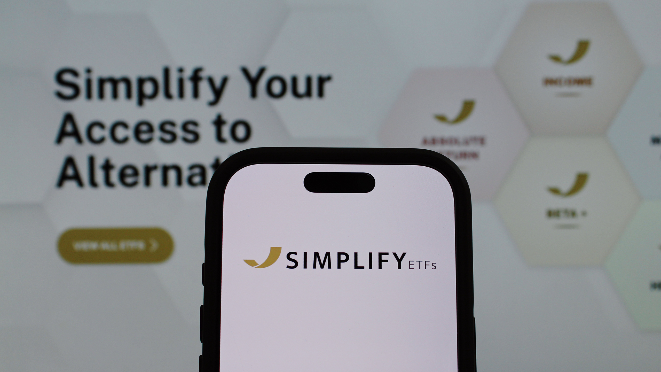 Photo of the Simplify ETFs website and logo