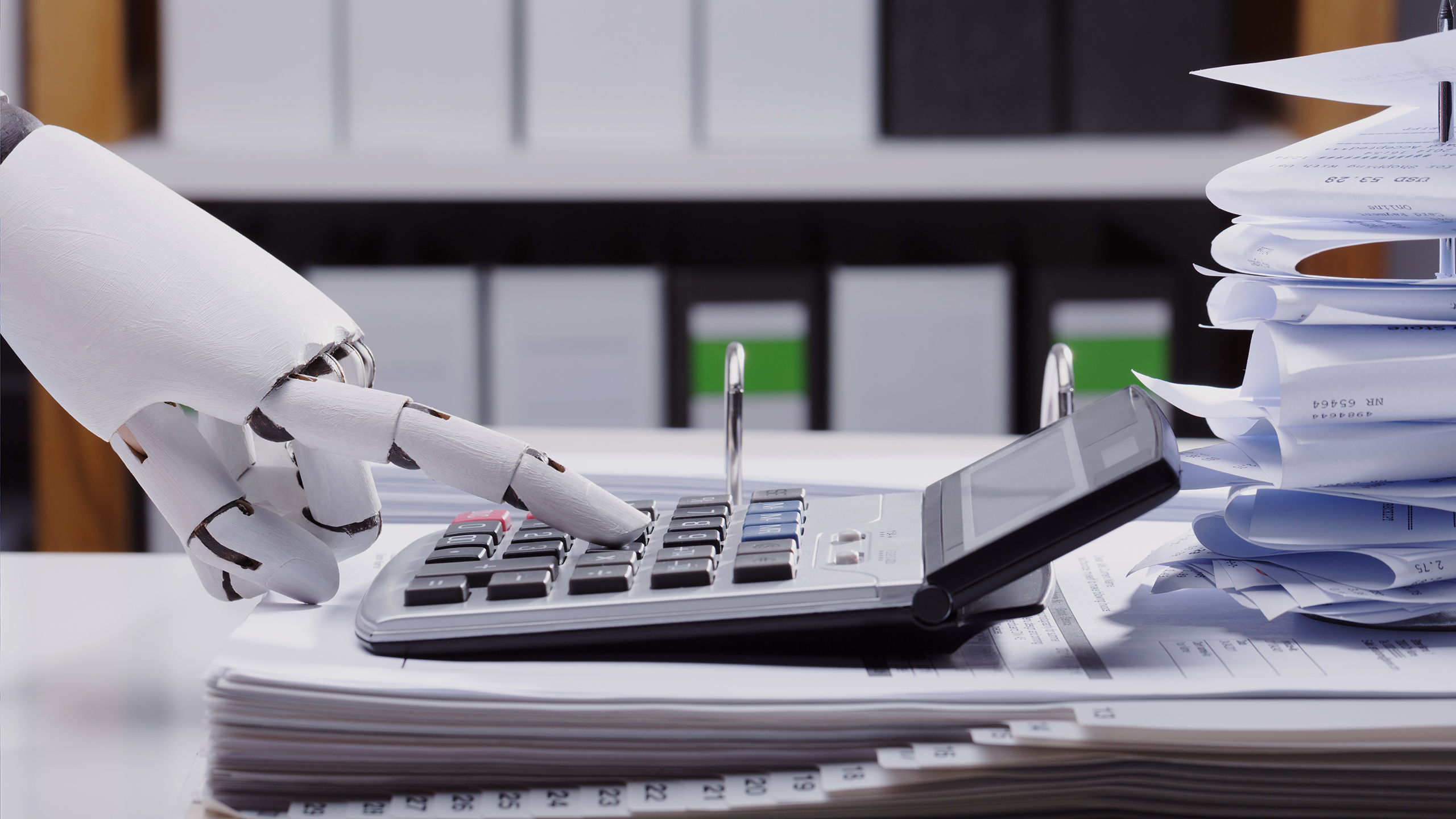 Photo of a robot using a calculator