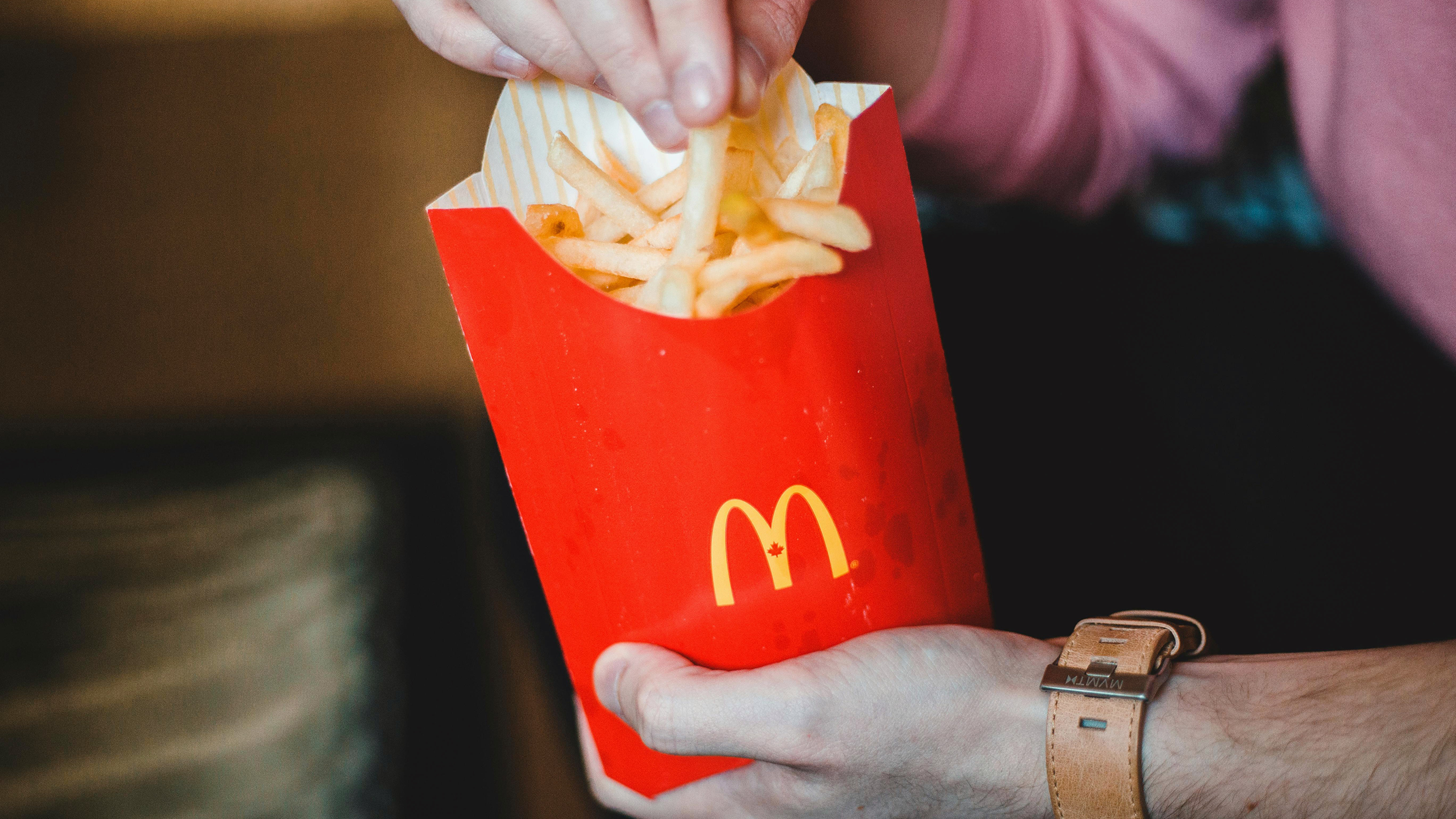 Photo of a person eating McDonald's fries