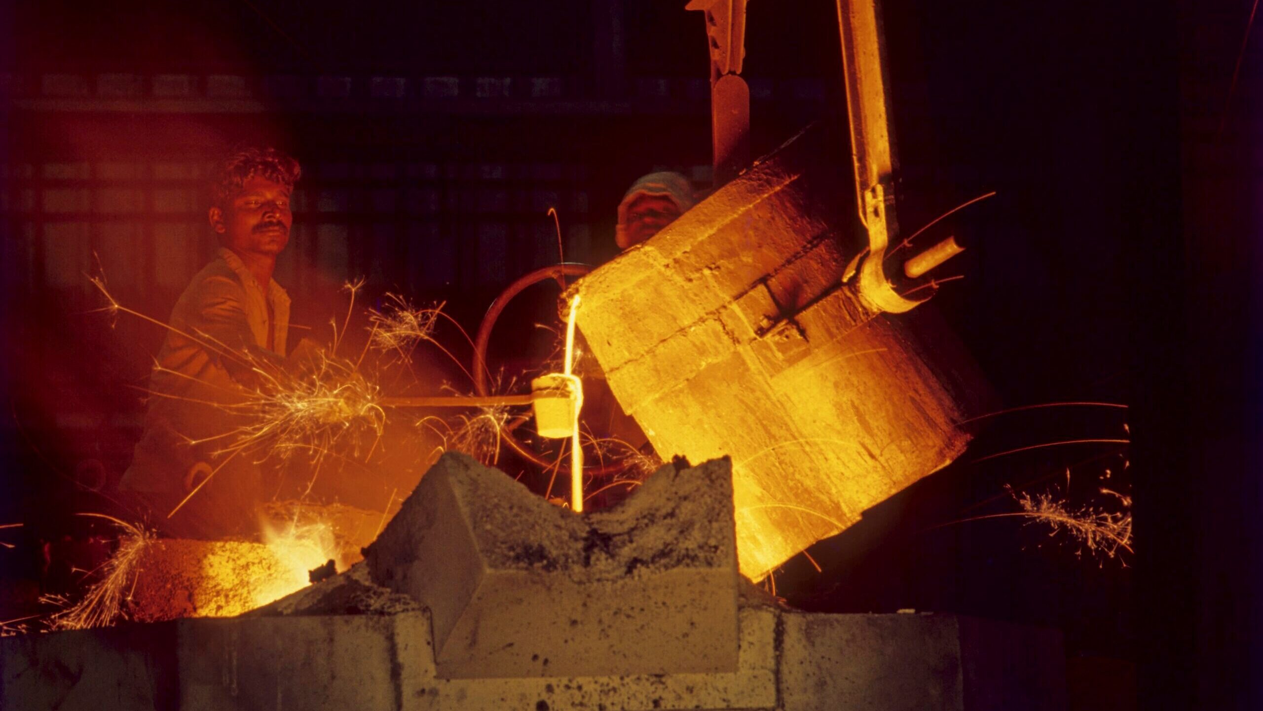 Photo of workers at a steel mill.