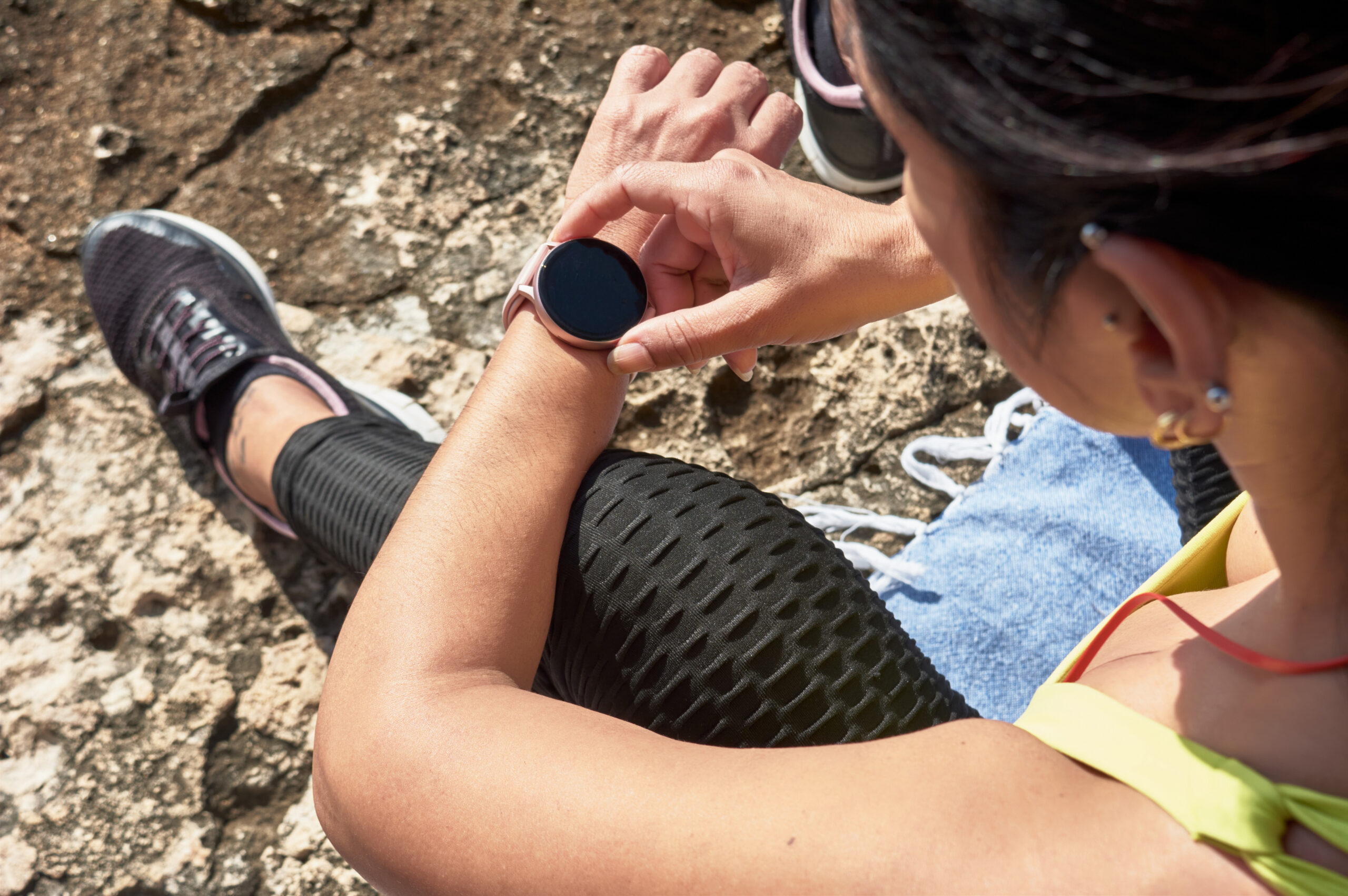 Photo of a woman looking at a smartwatch.