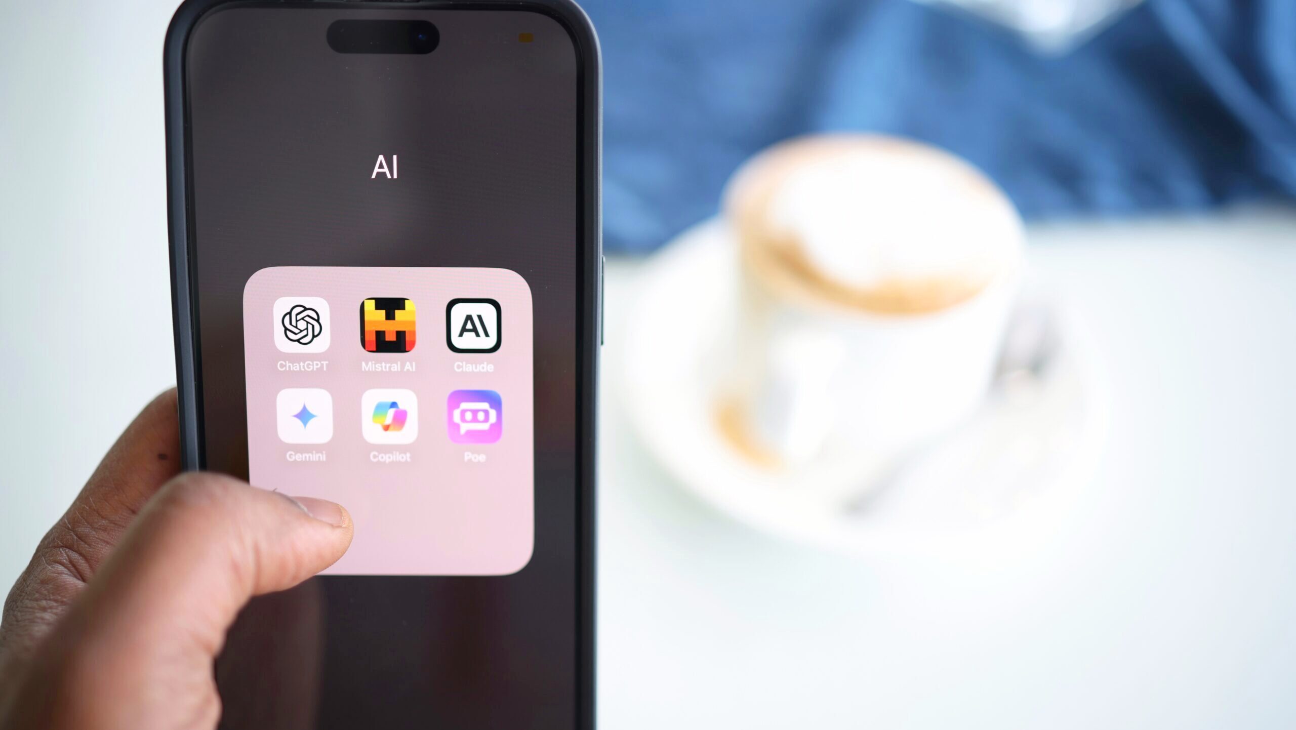 Photo of an iPhone home screen displaying various AI chatbot app icons.