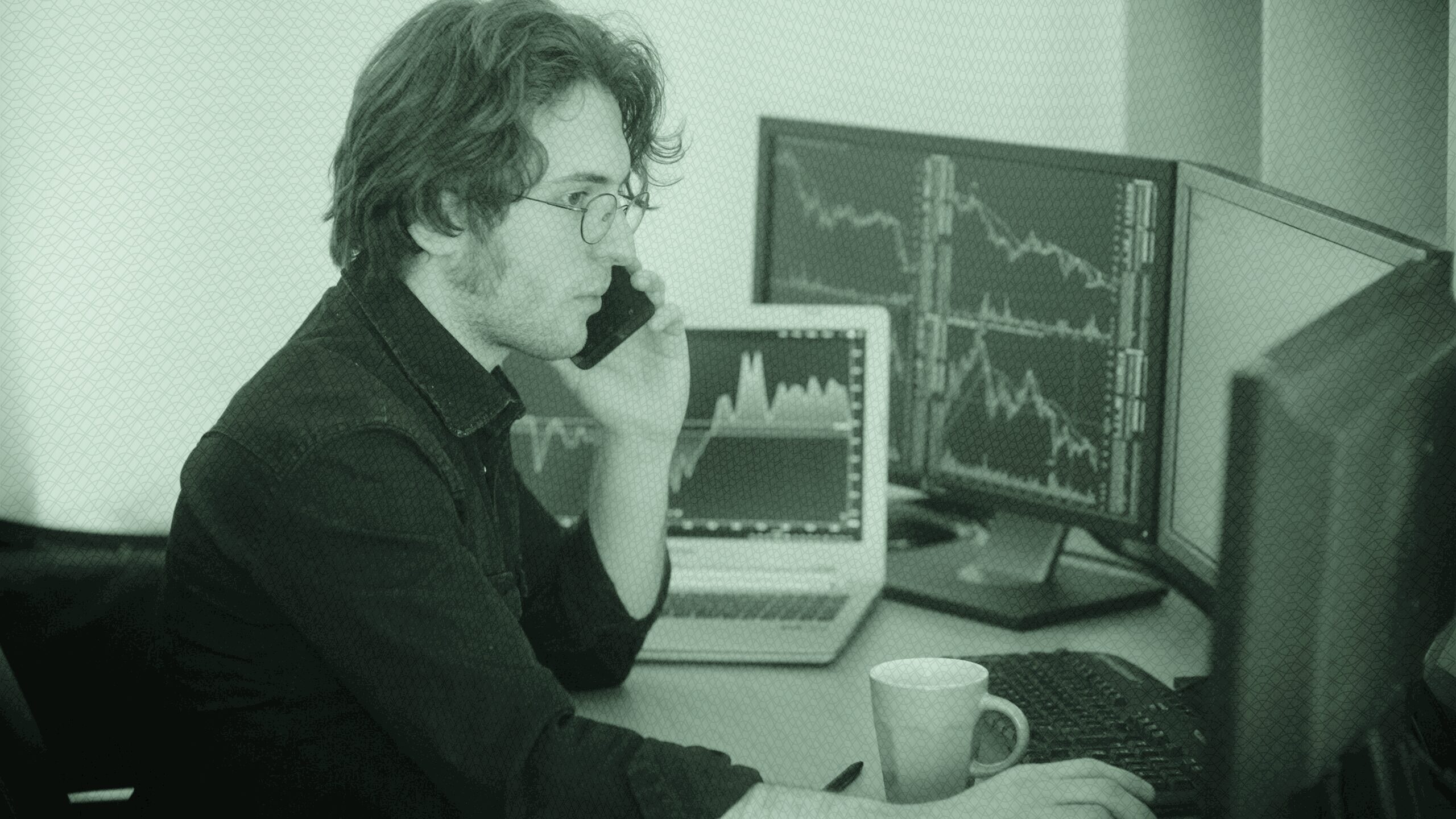 A man at a desk, working on investments.