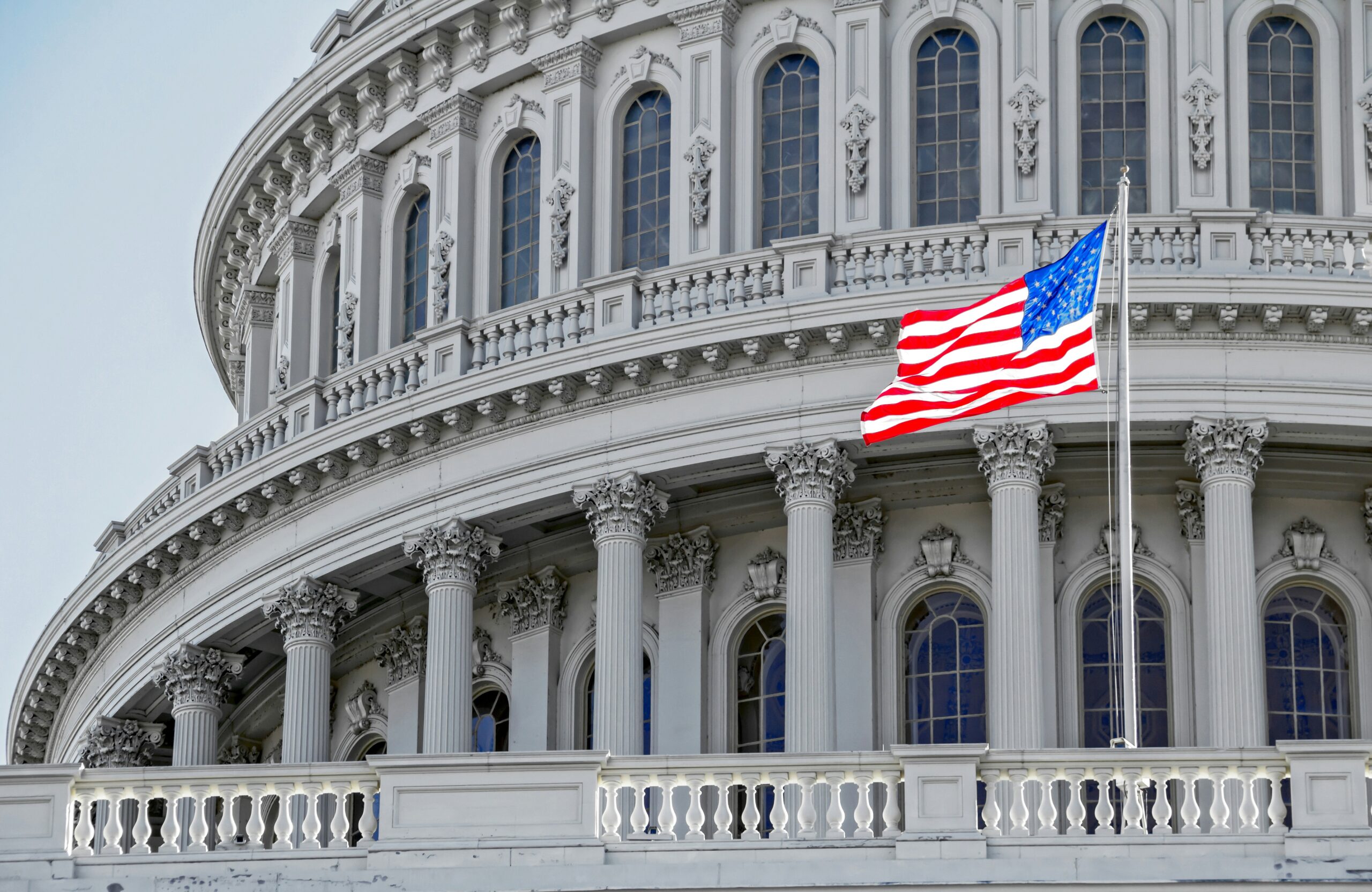 Image of the Capitol Building with an American flag.