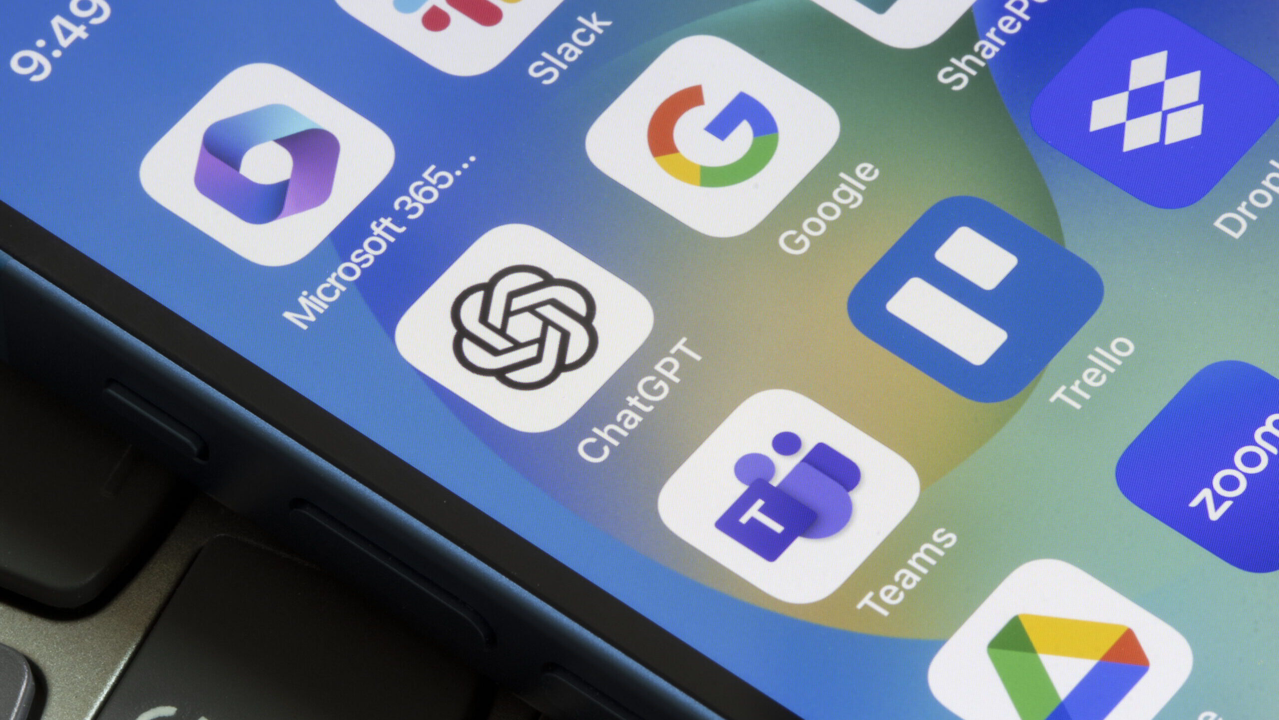 Apps from Google and Microsoft are seen on a phone screen alongside others including ChatGPT and Zoom.