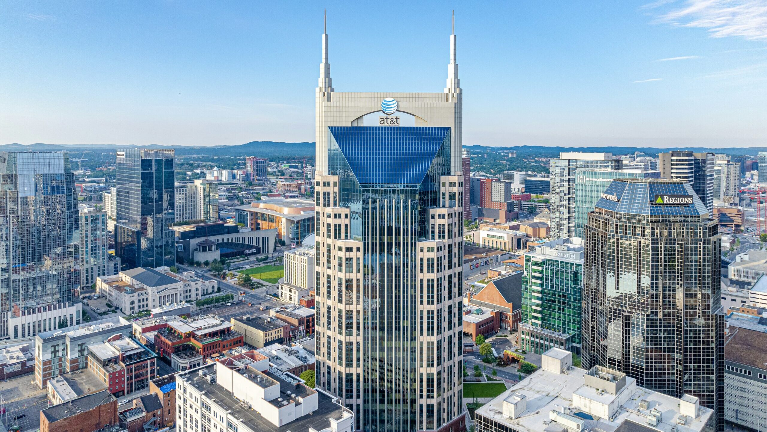 The AT&T buiding in downtown Nashville, TN features the company's logo atop the city skyline.