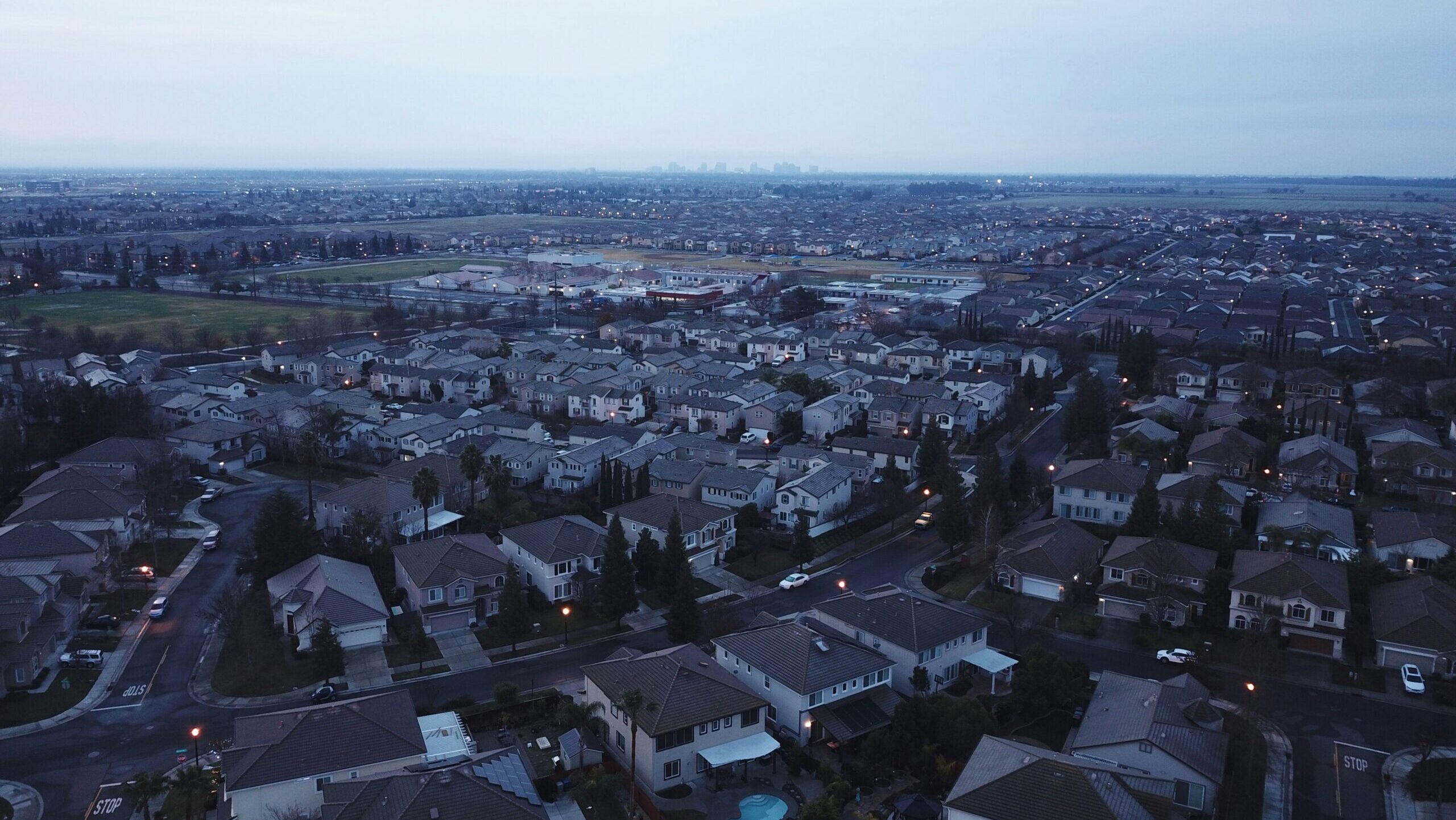 An area containing residential homes in Sacramento, California is shown looking towards the city's downtown.