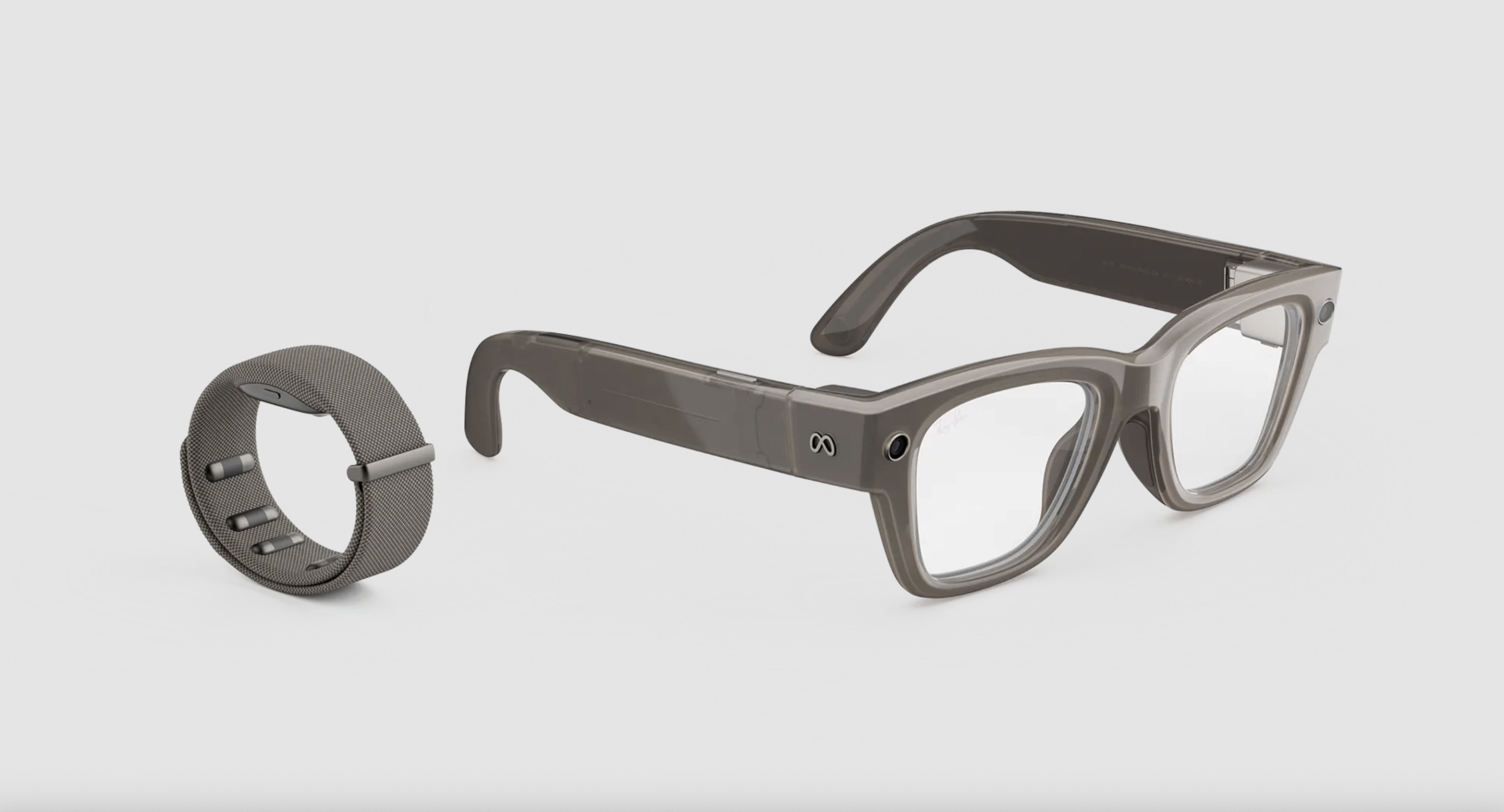 A Meta Neural Band is shown next to a pair of Meta Ray-Ban Display glasses.