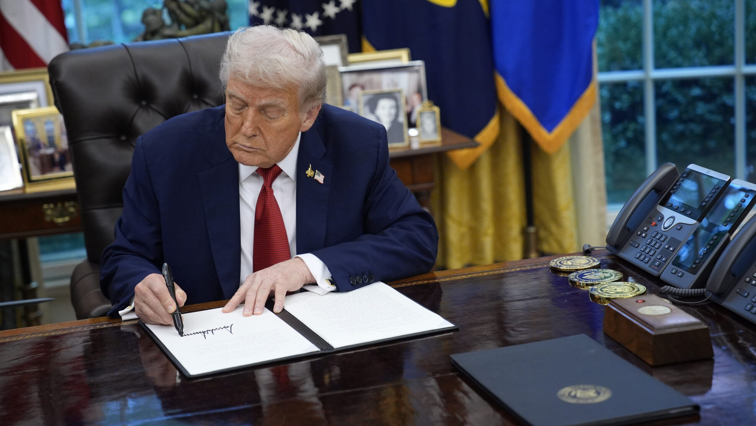 President Donald Trump signs an executive order regarding TikTok in the Oval Office at the White House in Washington DC on Thursday, September 25, 2025.