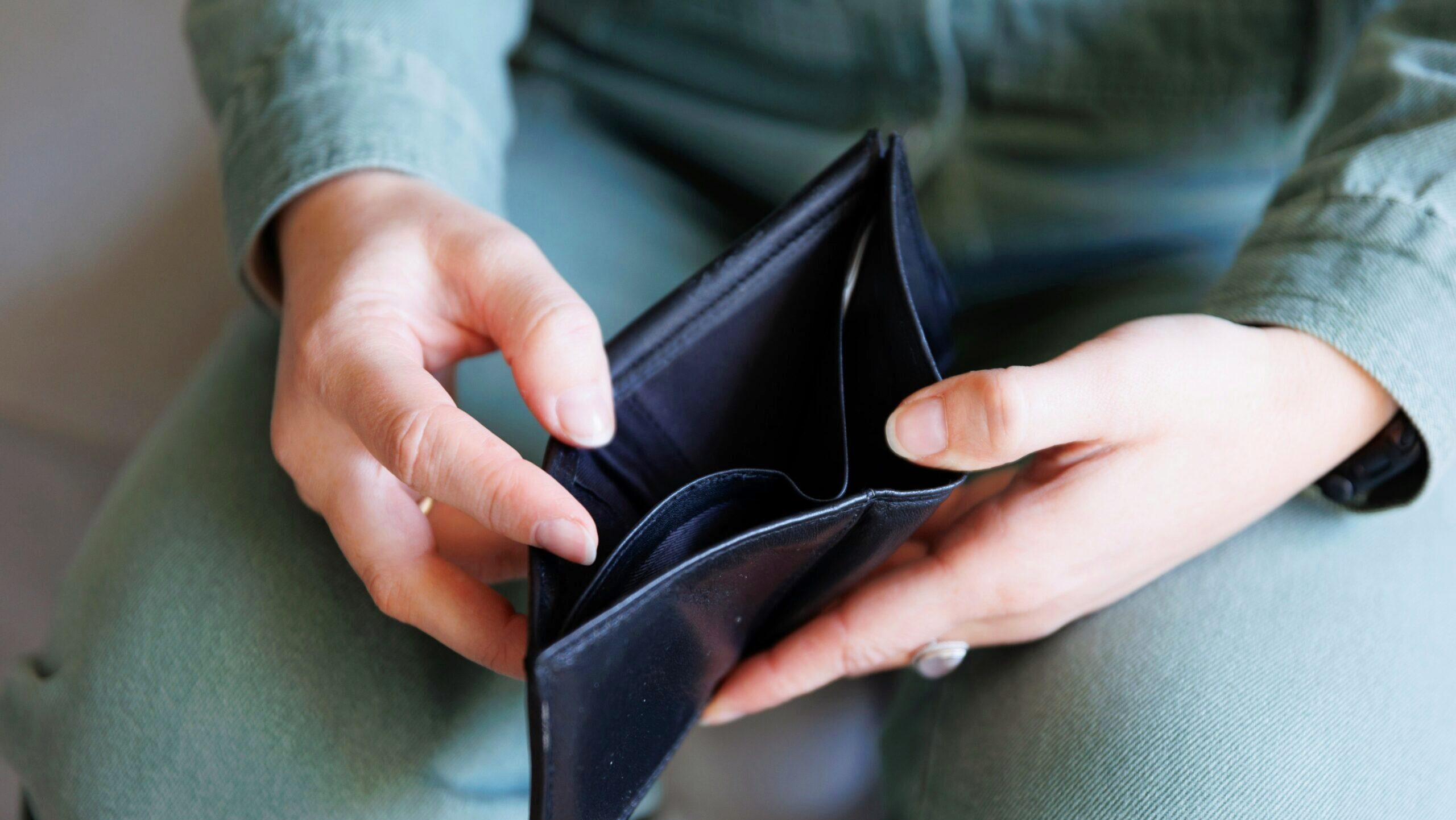 Photo of a person opening an empty wallet