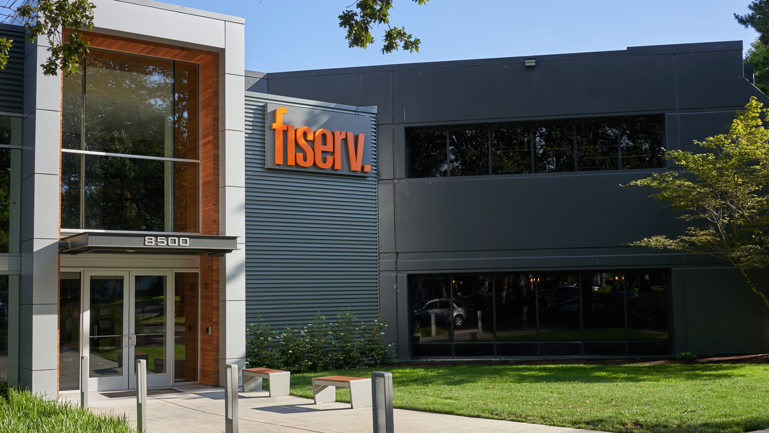 The exterior of a Fiserv office with the company's letter text logo is shown.