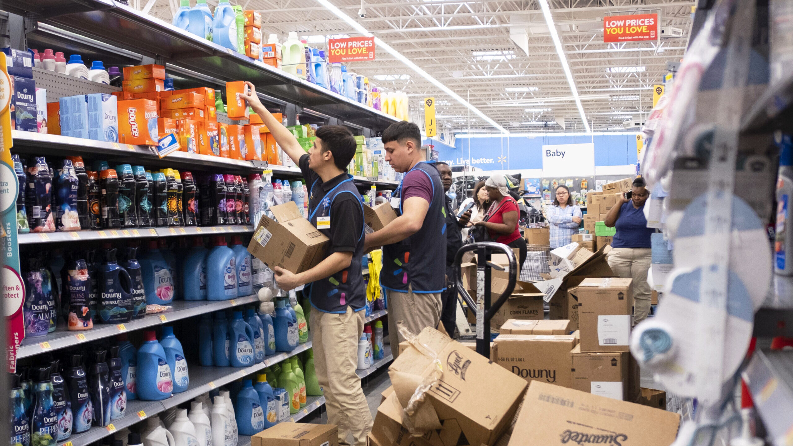 Photo of Walmart employees stocking shelves.