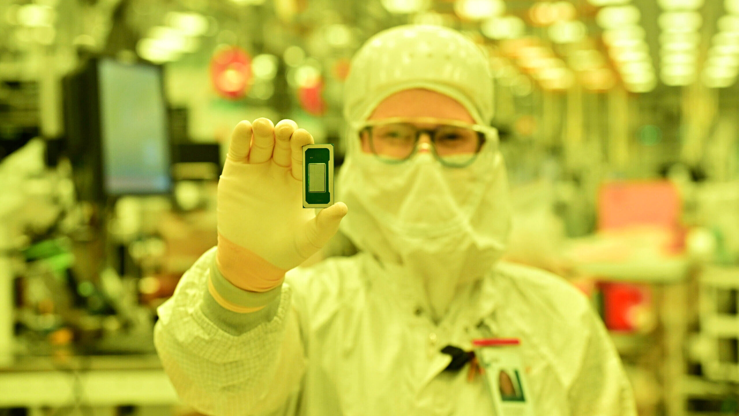 Photo of an Intel employee holding an Intel Panther Lake processor chip.