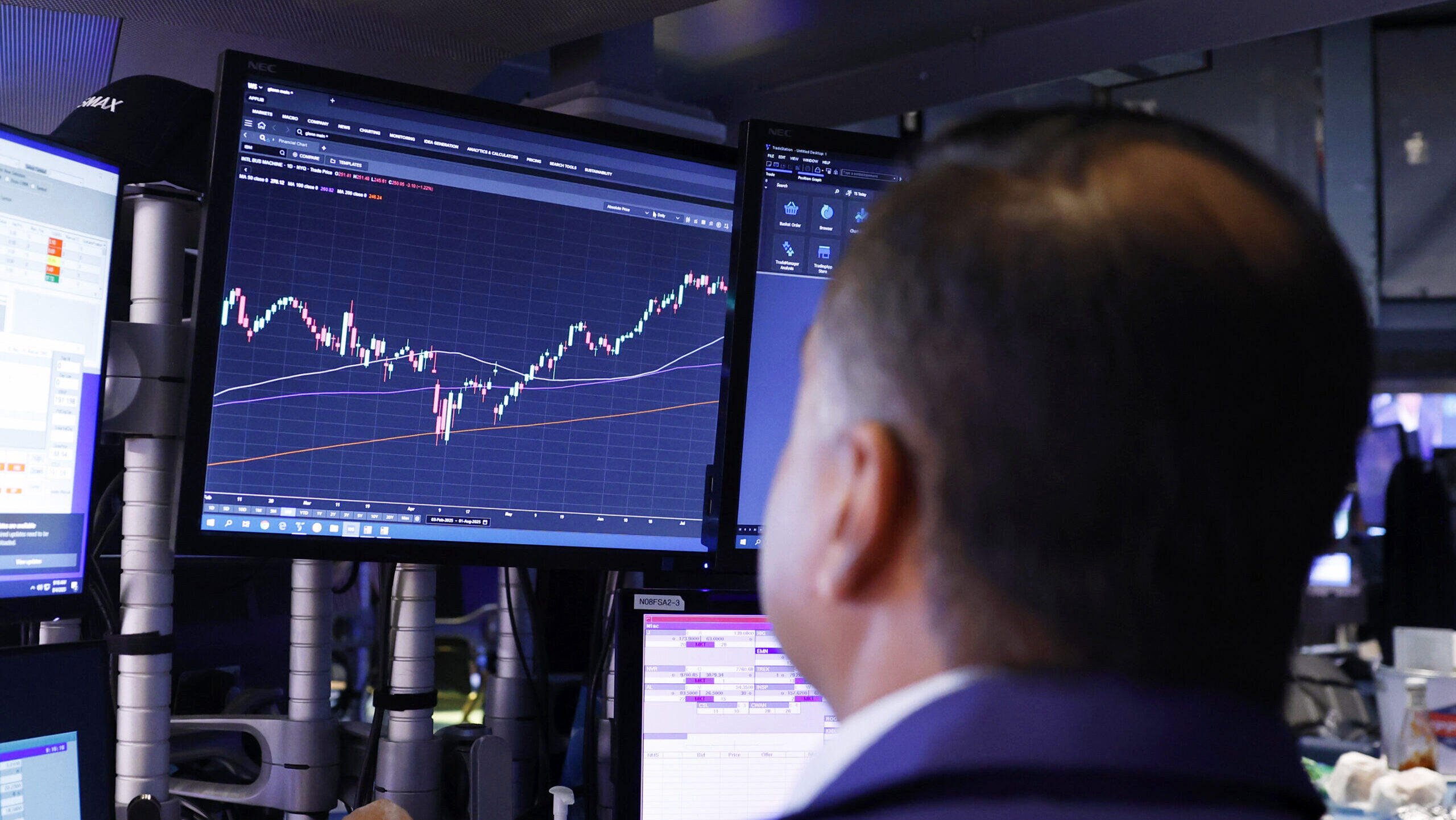 Photo of a man looking at a stock chart.