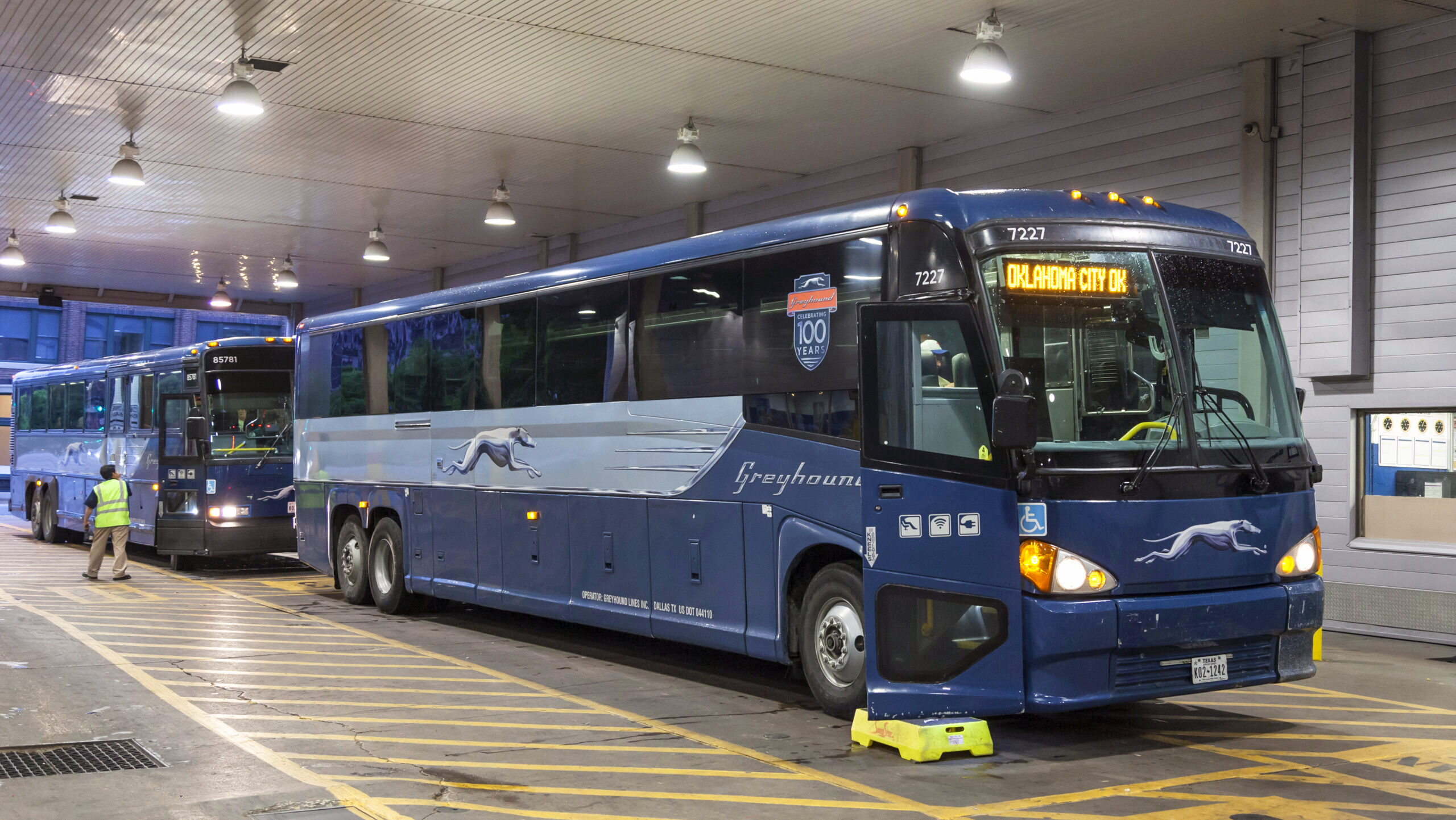 Greyhound buses are shown parked at a terminal in downtown Dallas, Texas.