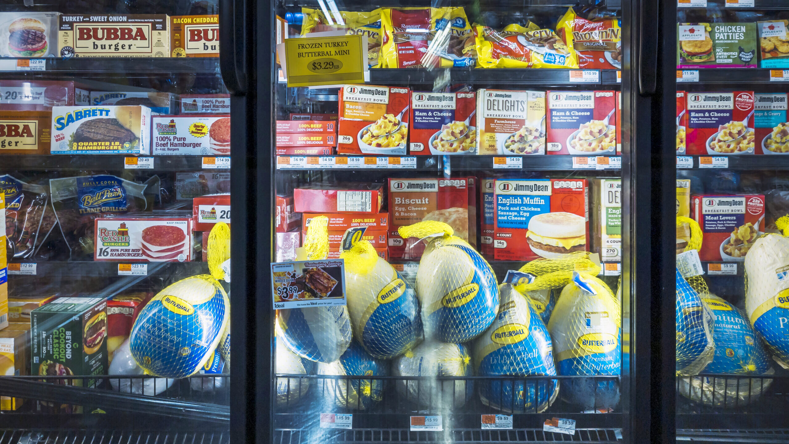 Photo of frozen turkeys at a grocery story.