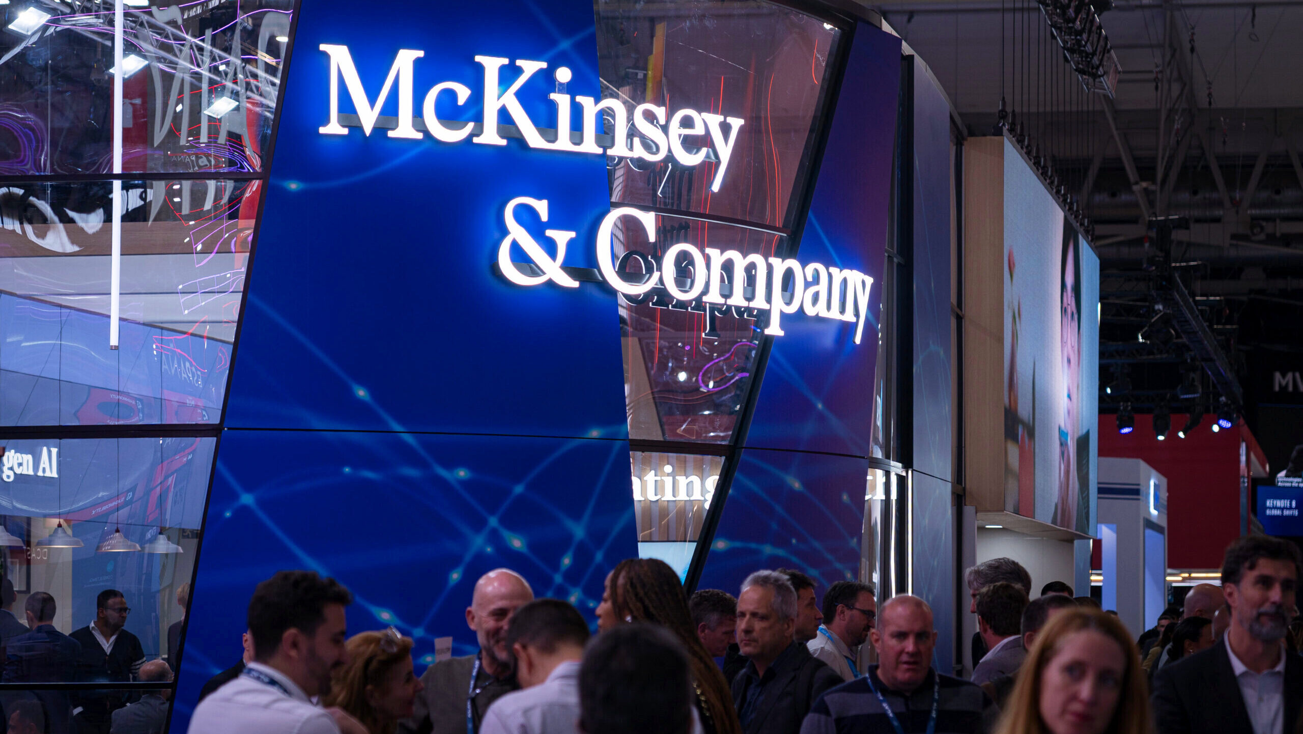 Photo of the McKinsey & Company logo at a convention booth.