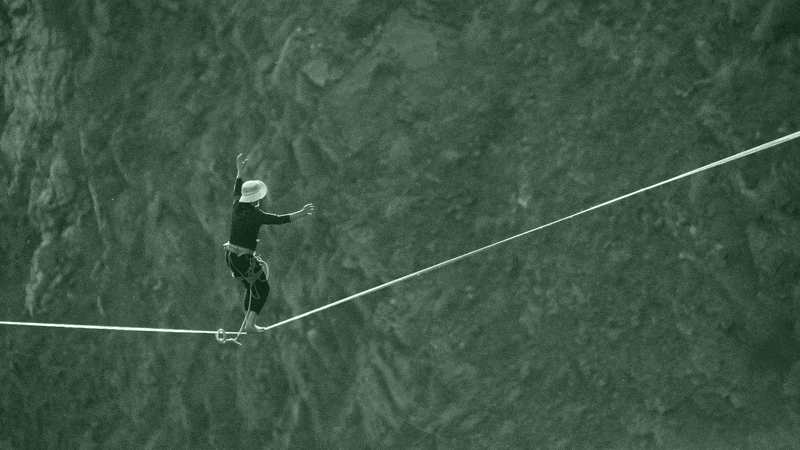 GIF of a person walking across a tightrope