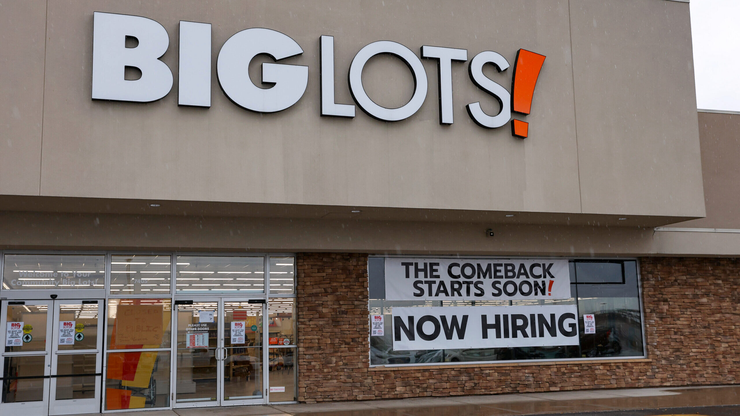 Photo of a "now hiring" sign outside a Big Lots store.