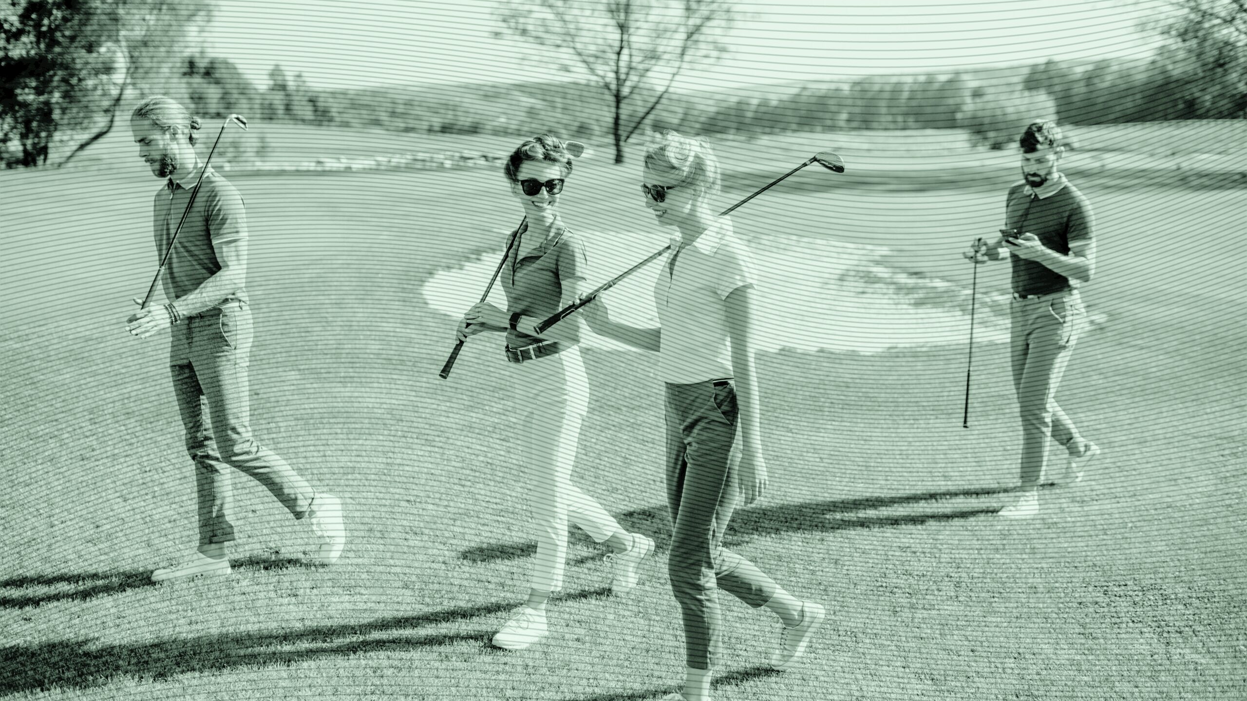 Four people golfing.