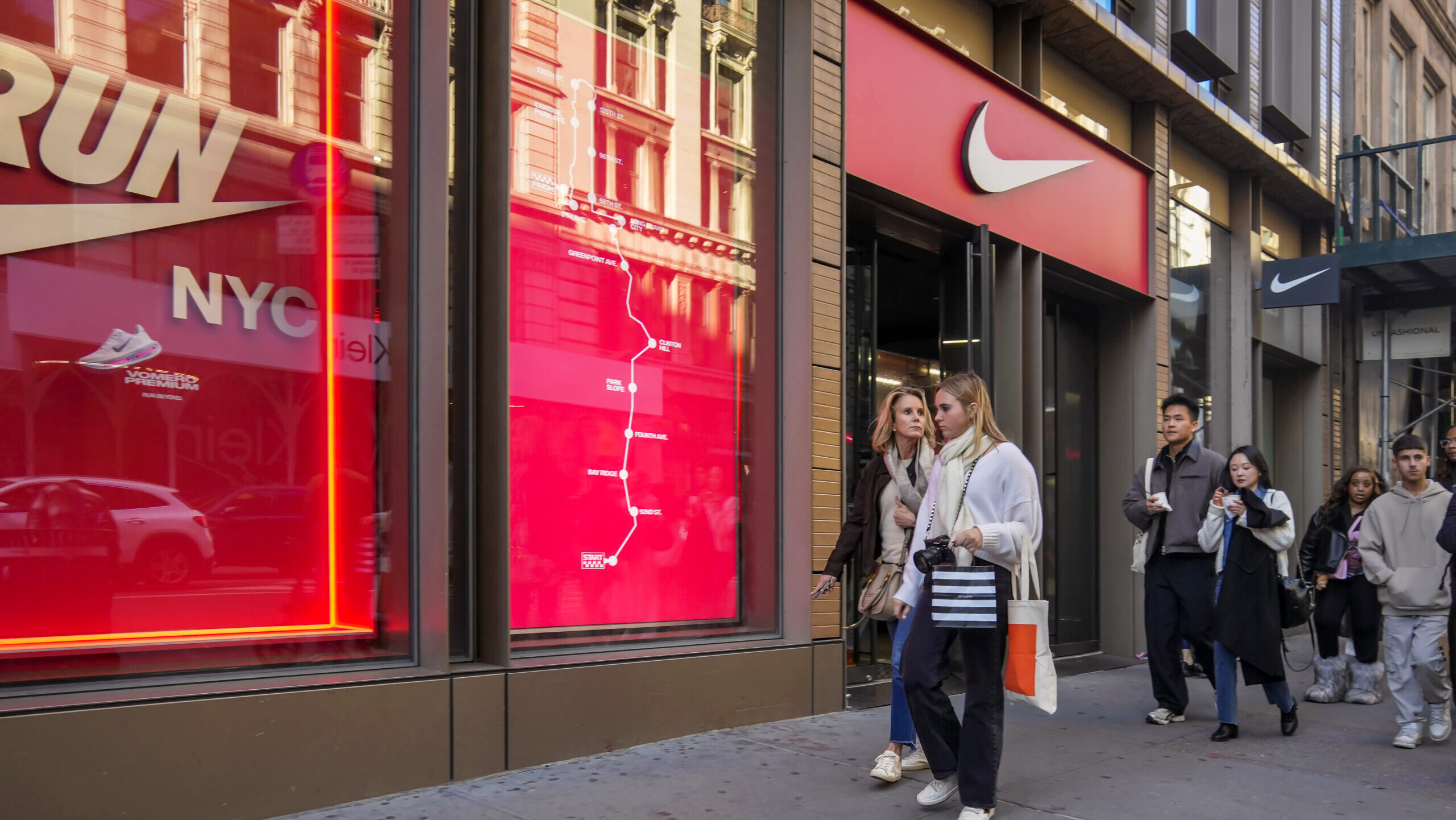 Photo of shoppers outside the Nike store in New York City.