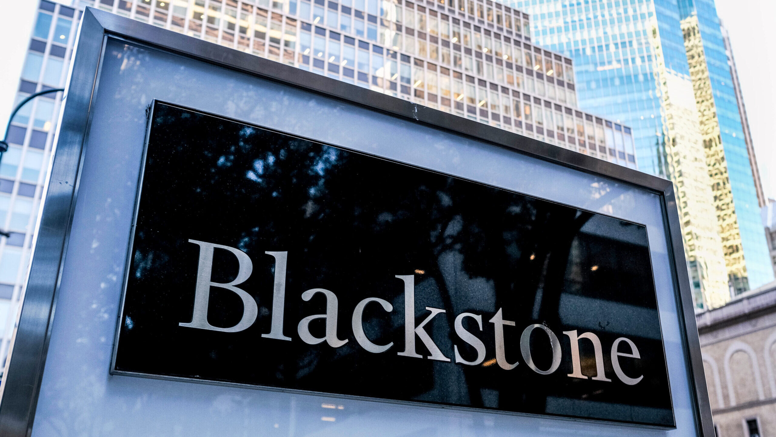 Photo of the Blackstone logo outside an office building.