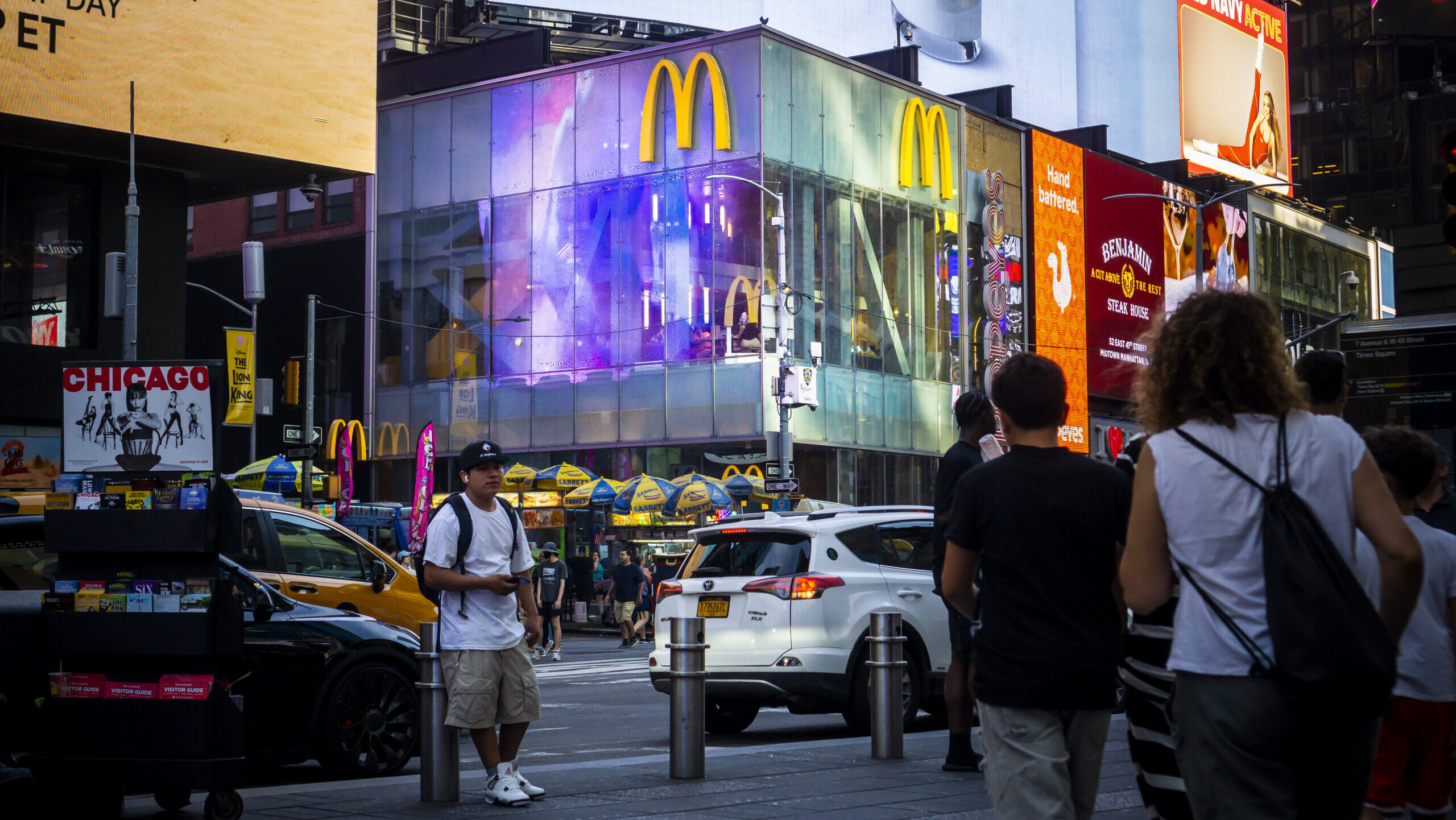 Crowds pass a McDonald's restaurant in Times Square in New York.