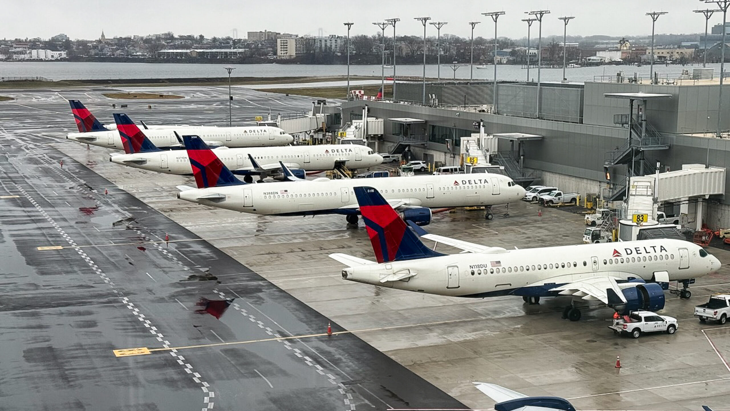 Delta Air Lines aircraft sit grounded at terminal gates at LaGuardia Airport in New York.
