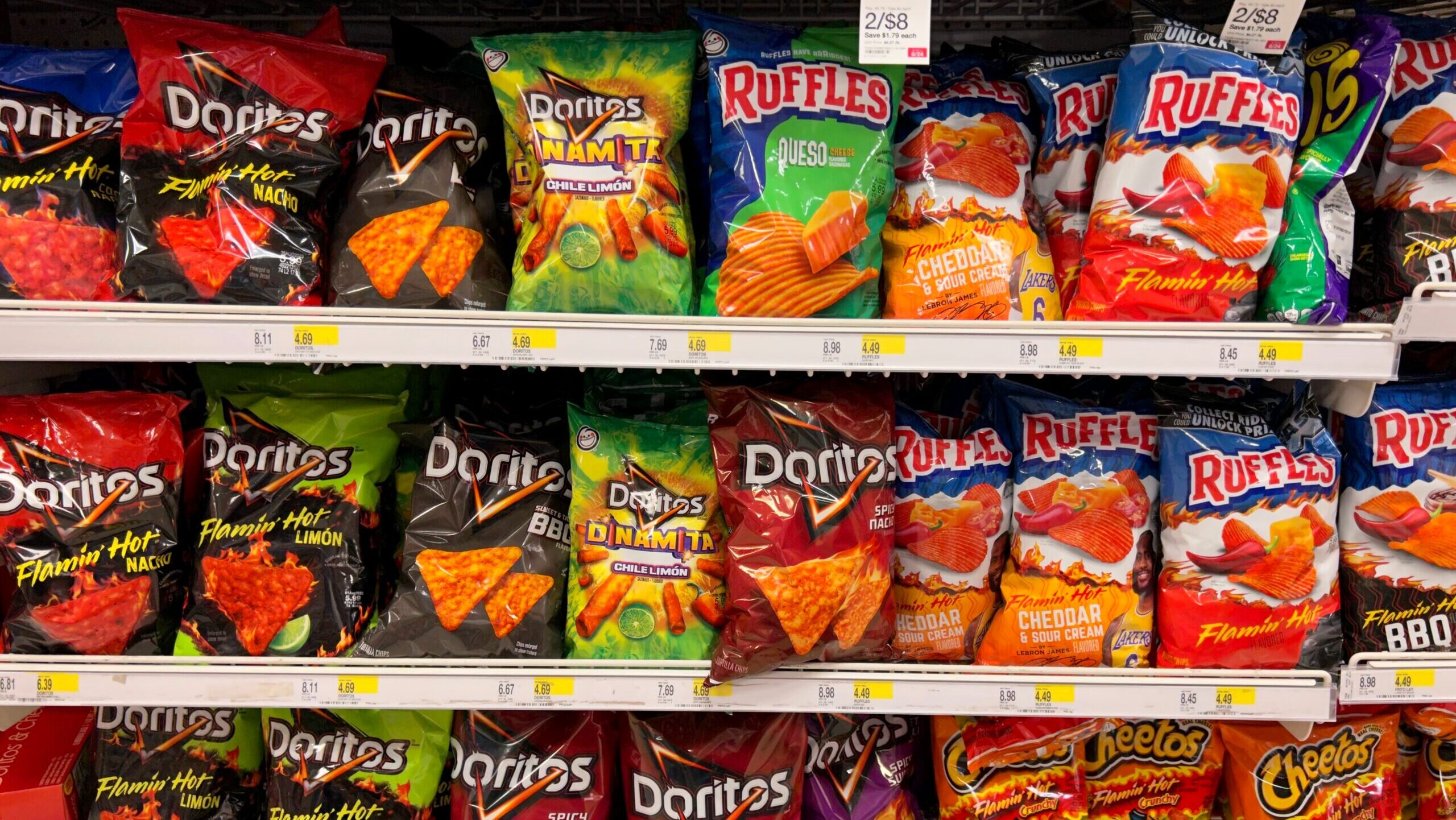 Photo of Doritos, Ruffles and Cheetos on a supermarket shelf.