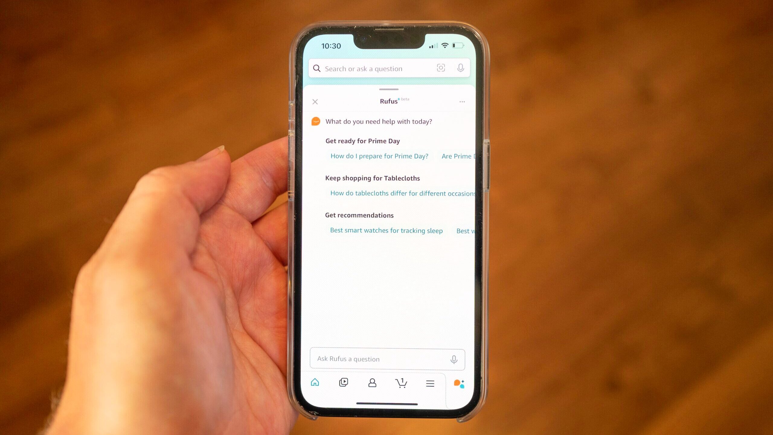 Photo of someone interacting with the Amazon Rufus AI system on an iPhone.