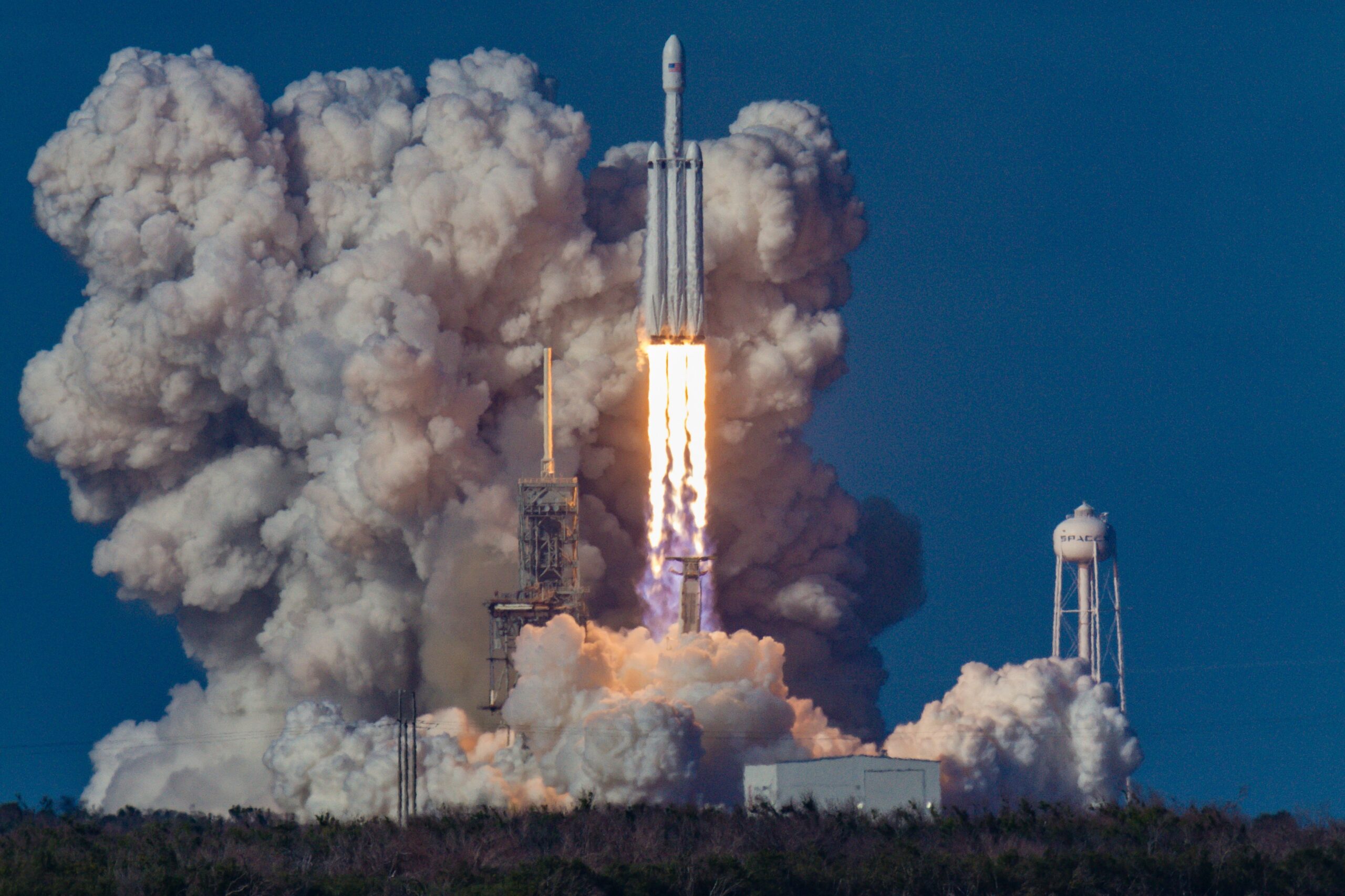 Photo of SpaceX Falcon 9 rocket taking off from a launch pad.