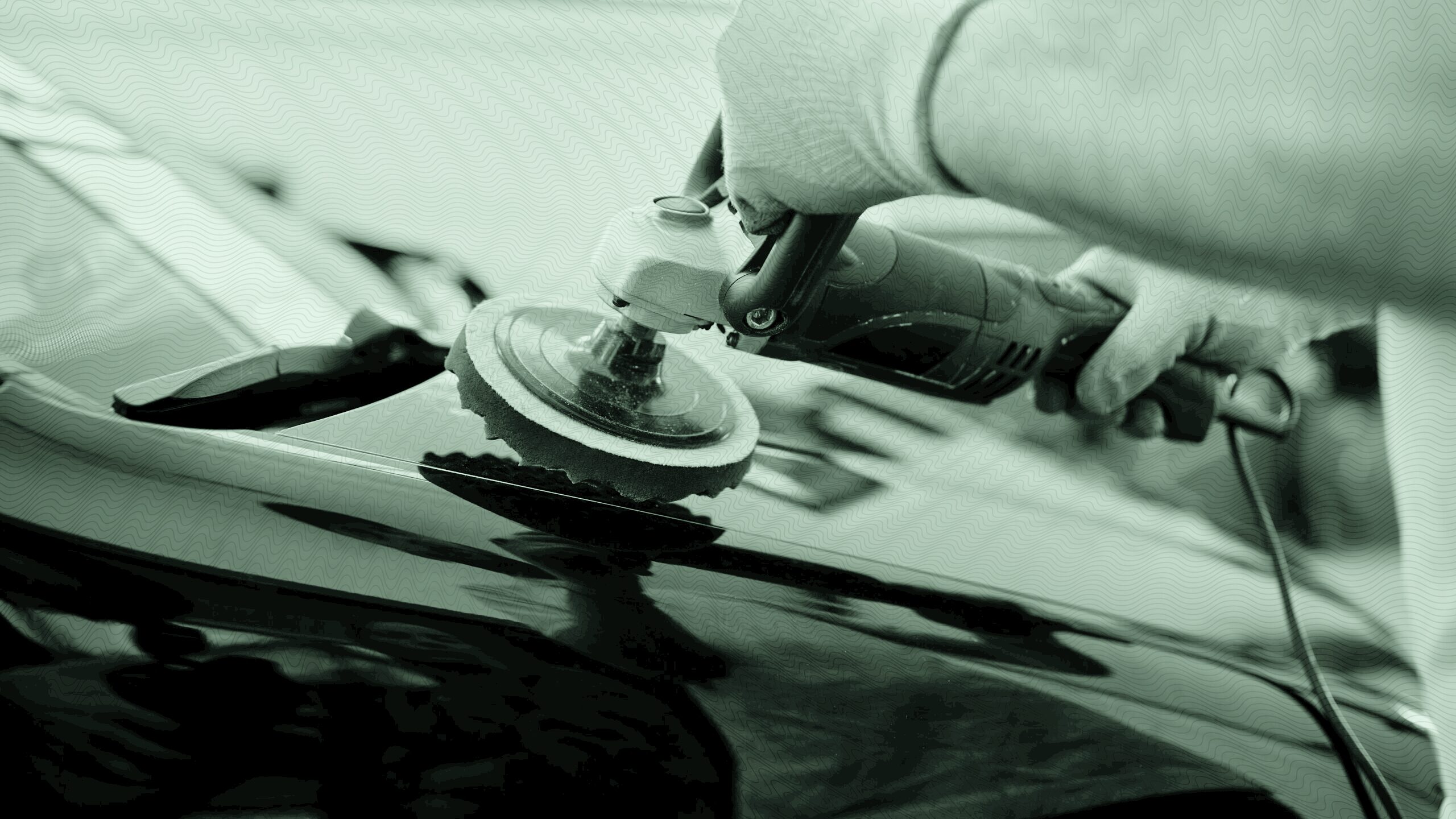 A person buffing a car.