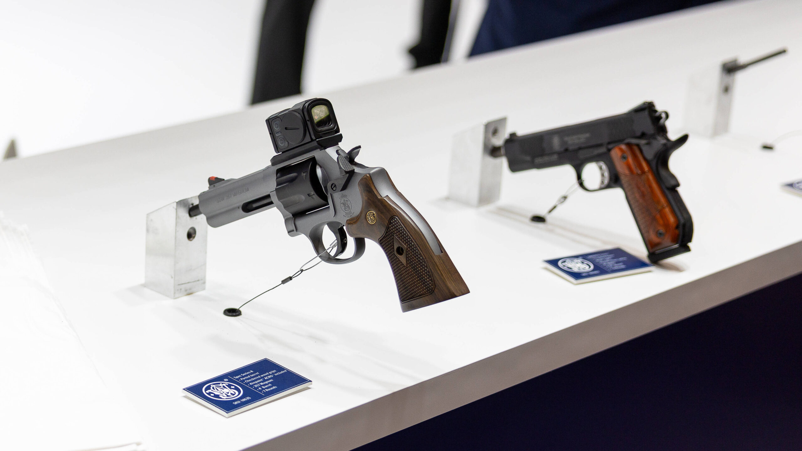 Photo of Smith & Wesson firearms on display at a trade show.
