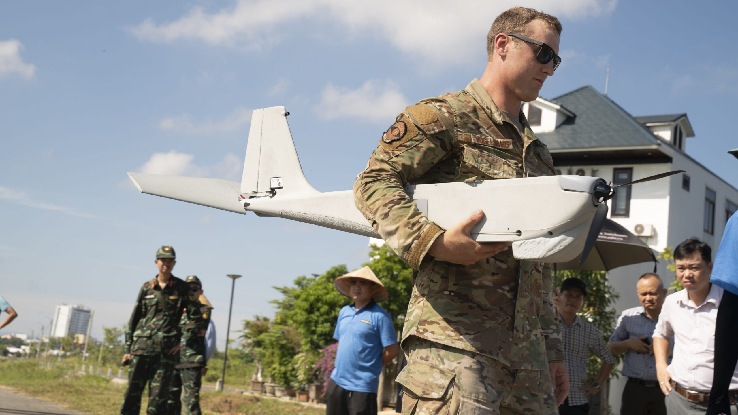 A National Guard member prepares to launch an AeroVironment RQ-20 Puma drone.