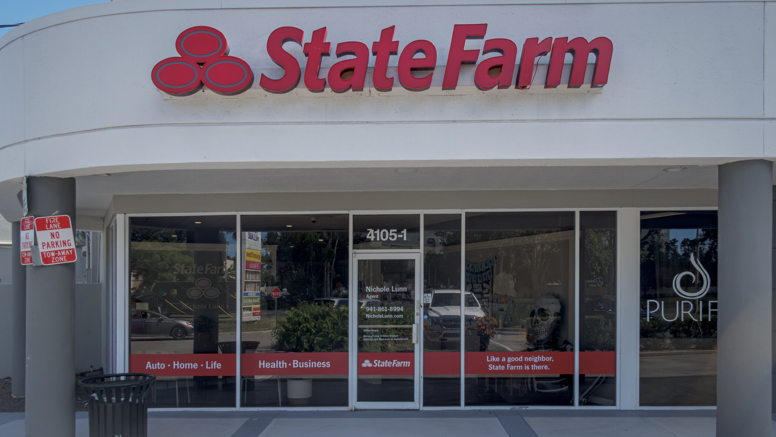 A State Farm storefront in Venice, Florida is shown on a sunny day.