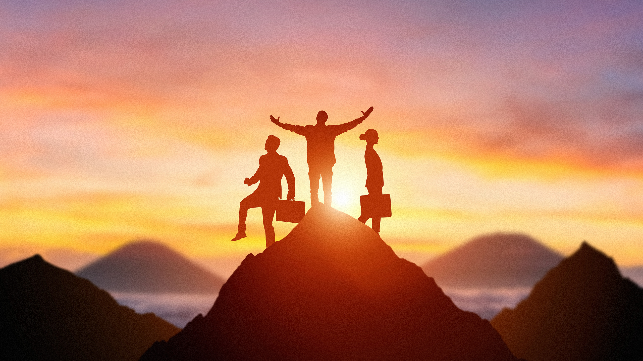 Photo illustration of the silhouettes of 3 business people standing at the top of a mountain