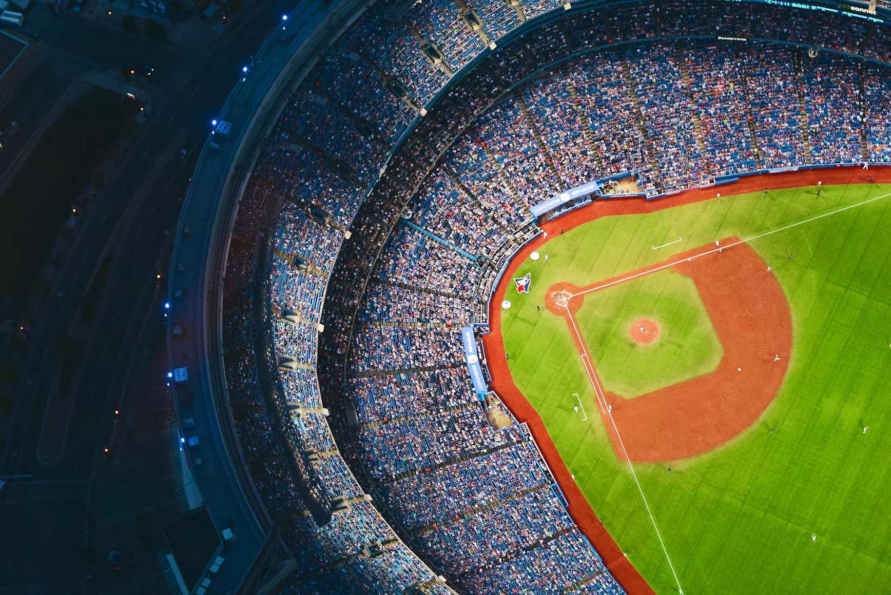 Overhead areal photo of a baseball stadium full of people.