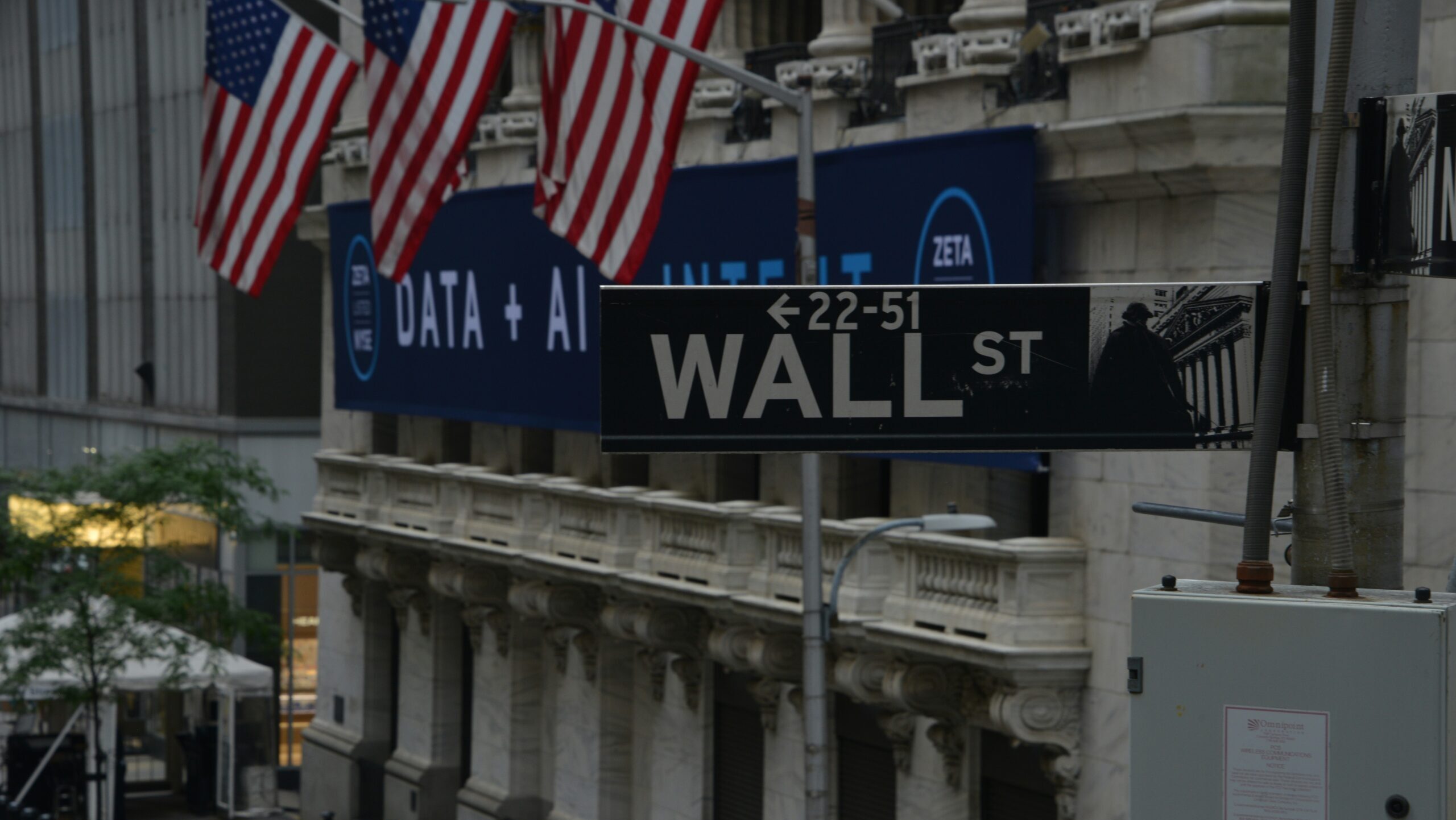 A Wall St. street sign is shown in front of the New York Stock Exchange in New York City's Financial District.