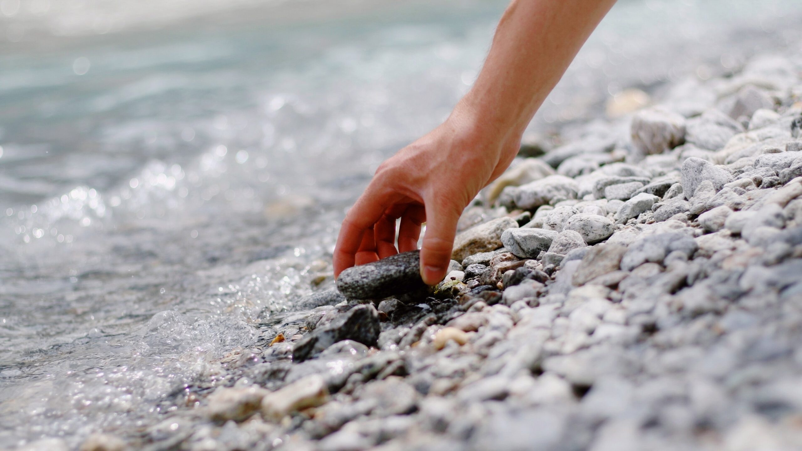 Photo of person picking up a rock