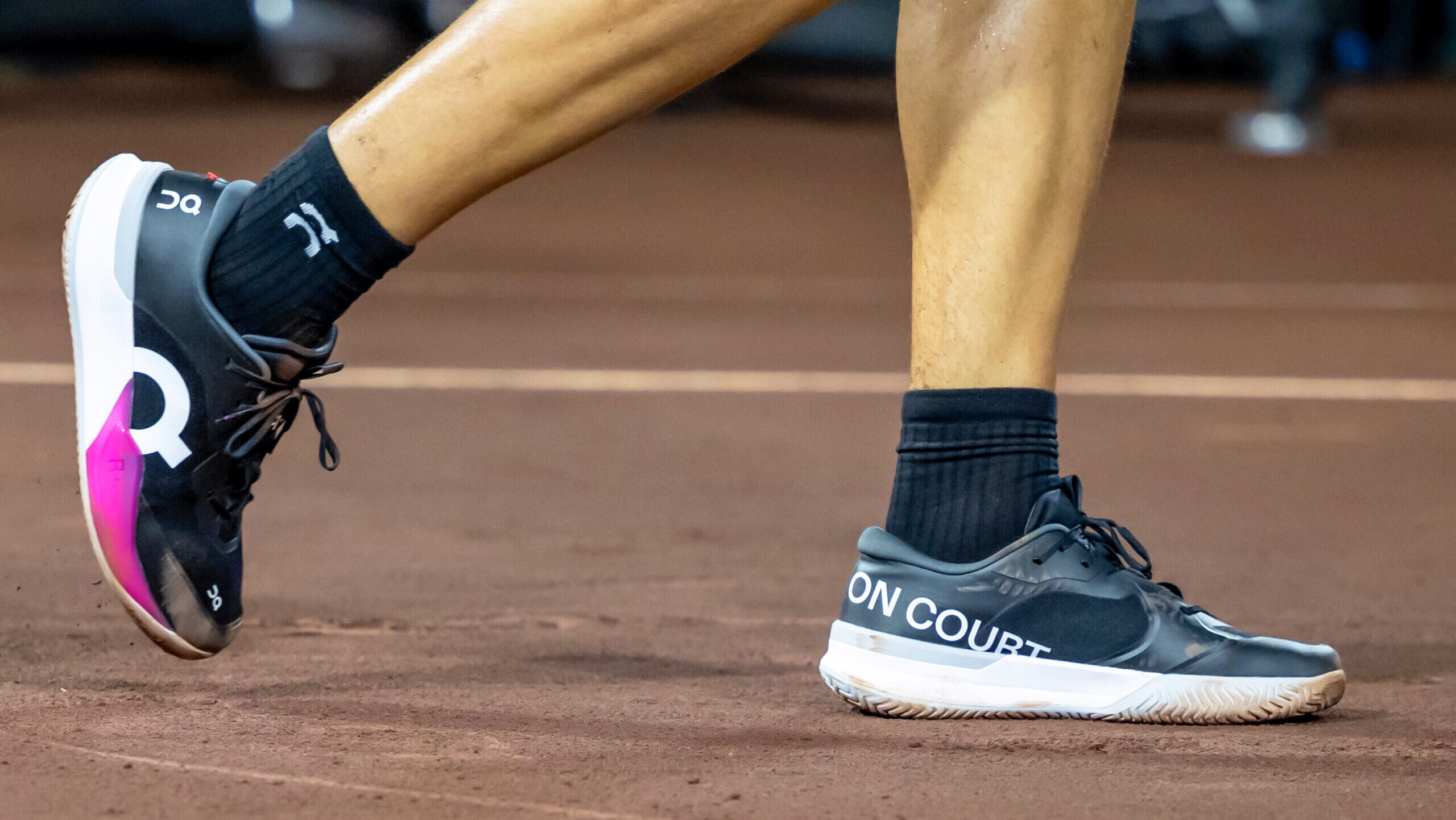 Photo of tennis pro Ben Shelton wearing On Cloud tennis shoes.