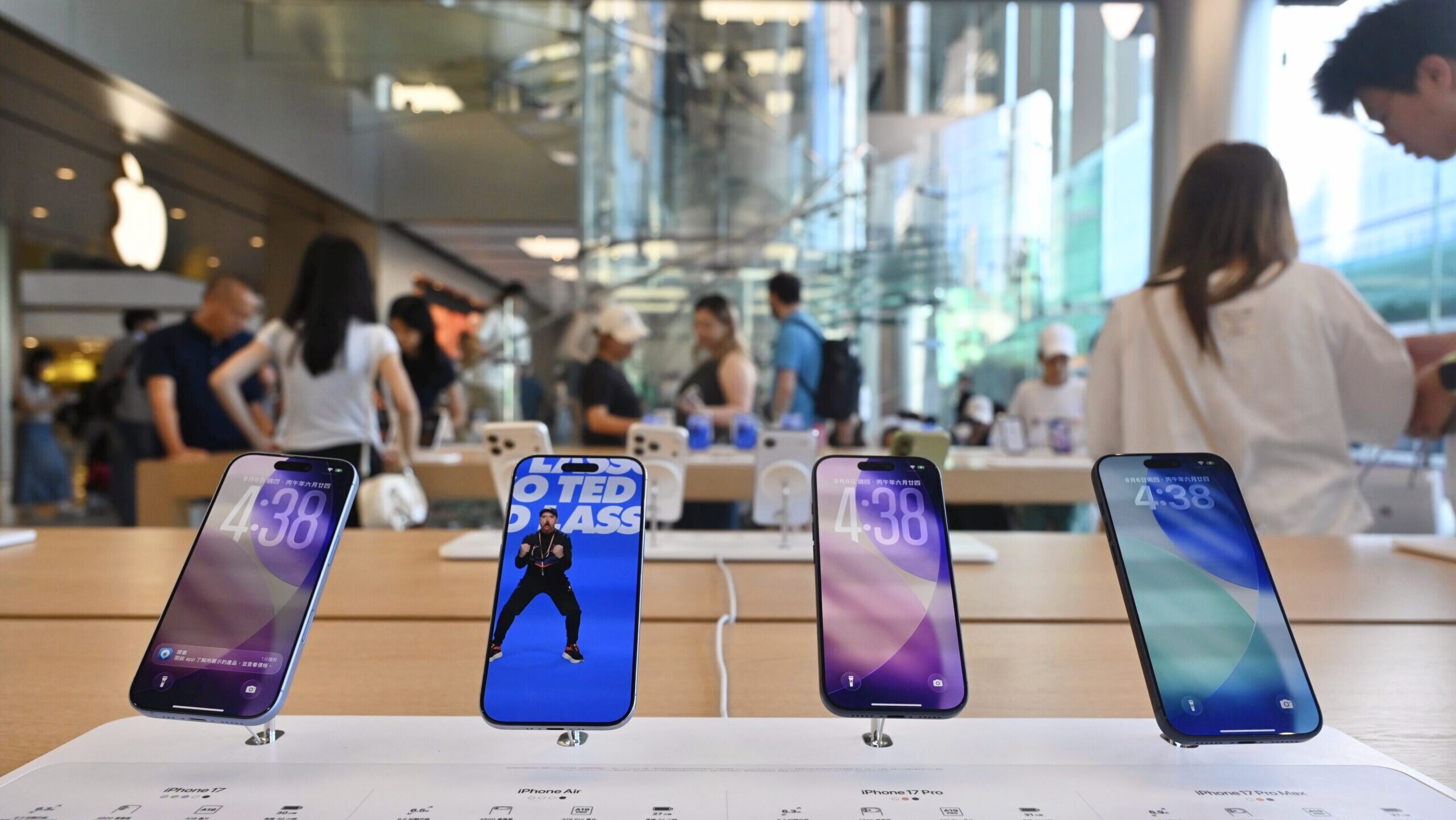 Photo of iPhone devices on display at an Apple Store.