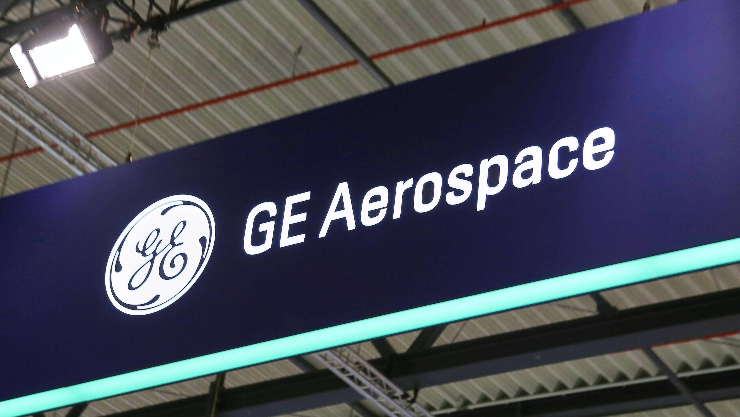 The GE Aerospace logo is displayed on a sign hanging from the roof at an industry conference.